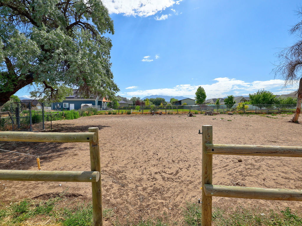 Expansive open lot with a rustic wood fence