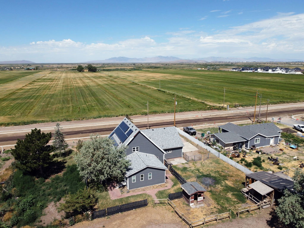 Residential property featuring a grey exterior and a substantial roof-mounted solar panel array