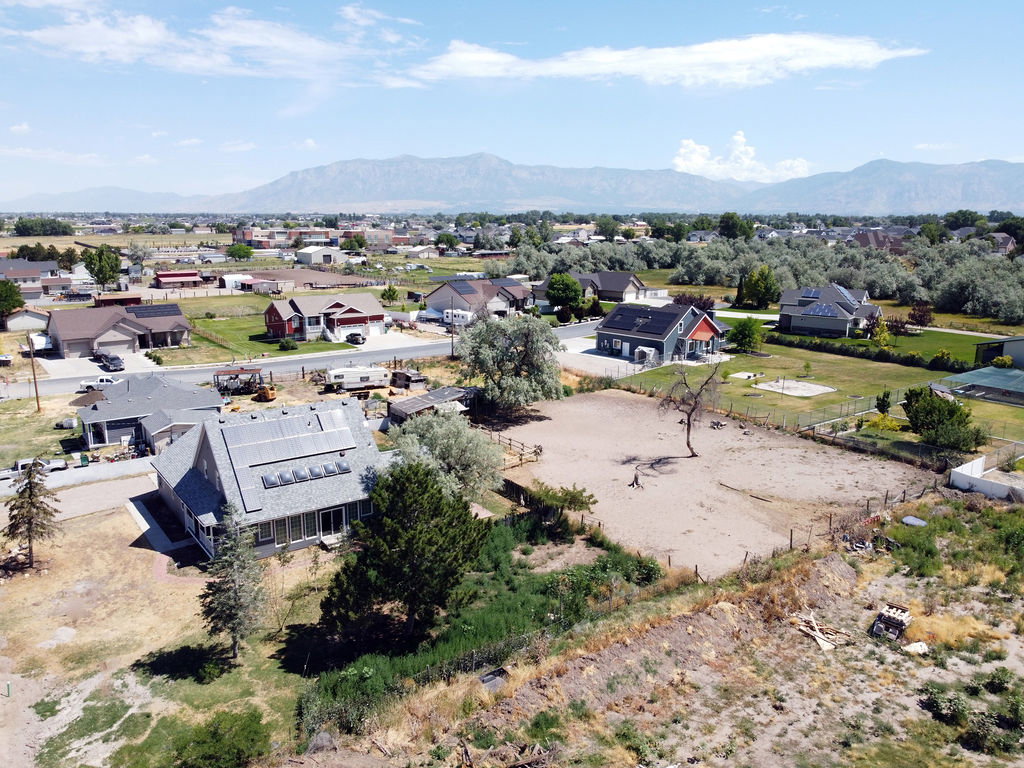 Expansive undeveloped lot with partial fencing and mature trees