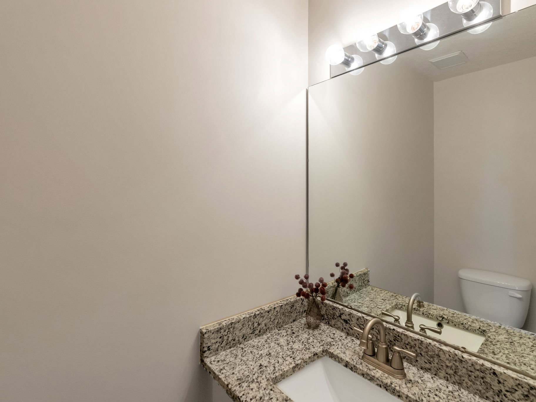 Granite-finish countertop with an undermount sink and brushed nickel faucet