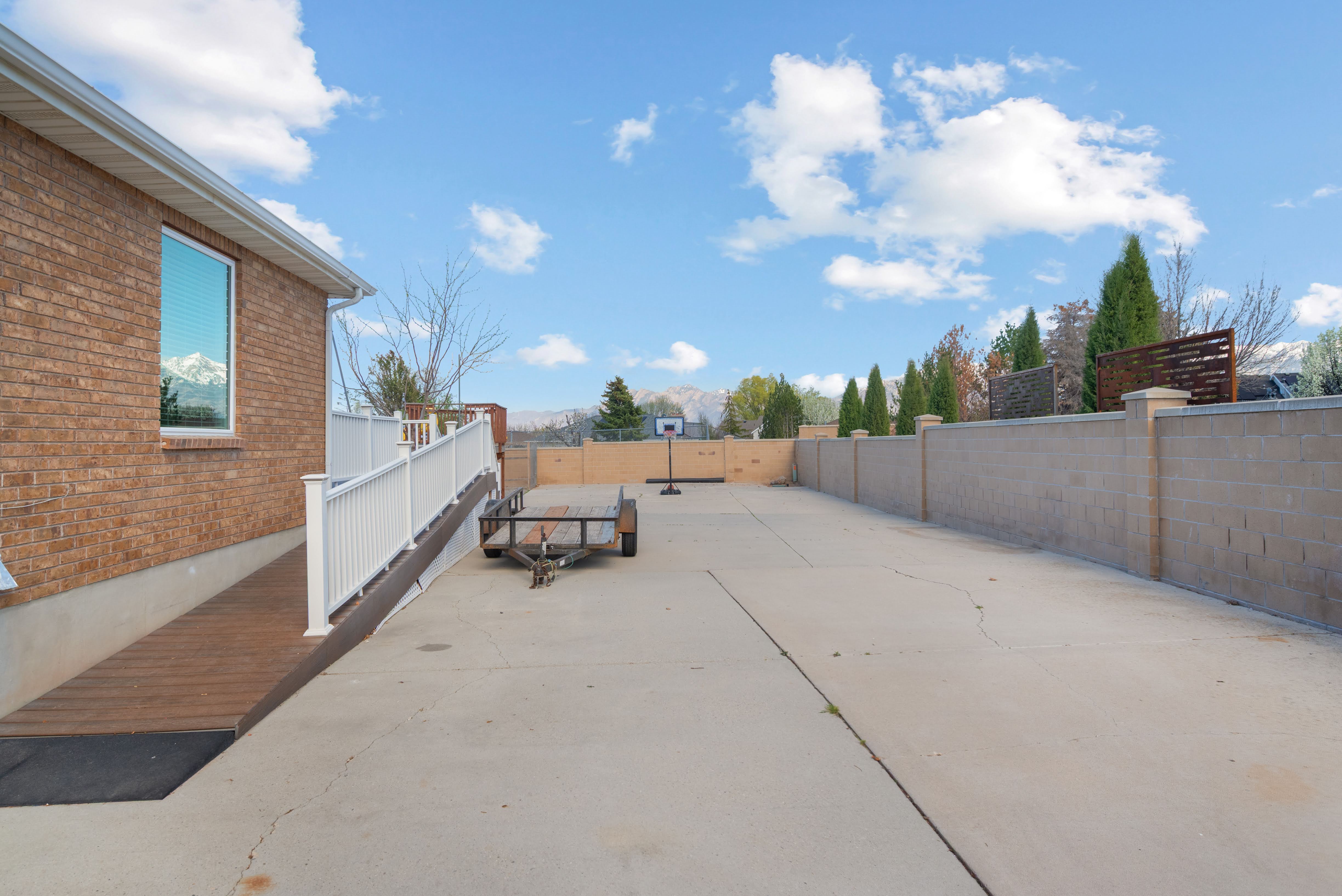 Expansive concrete patio with a brick exterior