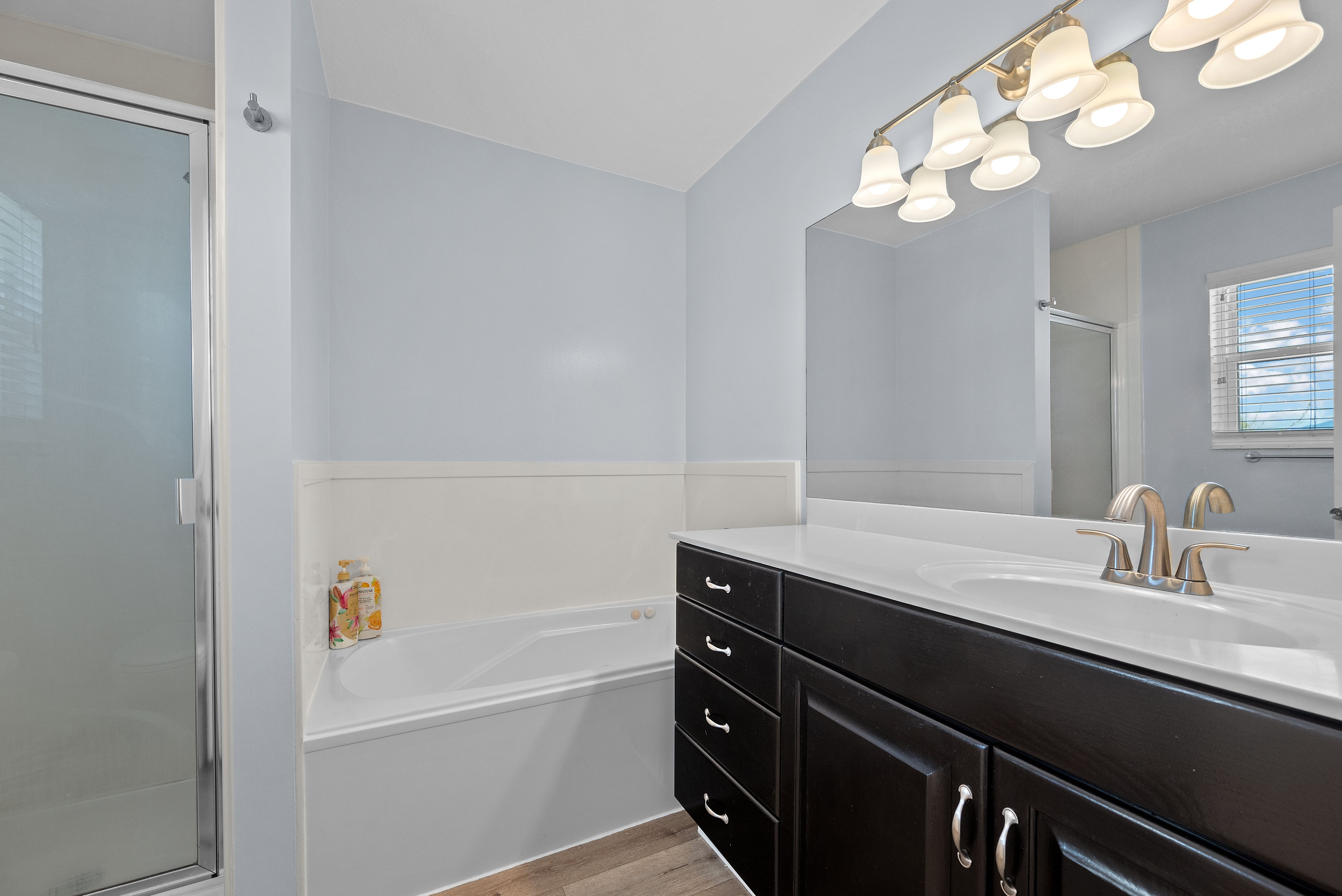 Bathroom featuring a dark wood-finish vanity with a white countertop and integrated sink