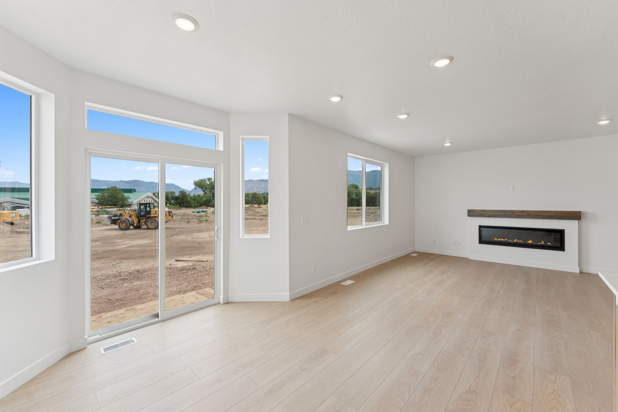 Bright living area featuring wood-finish flooring and recessed lighting