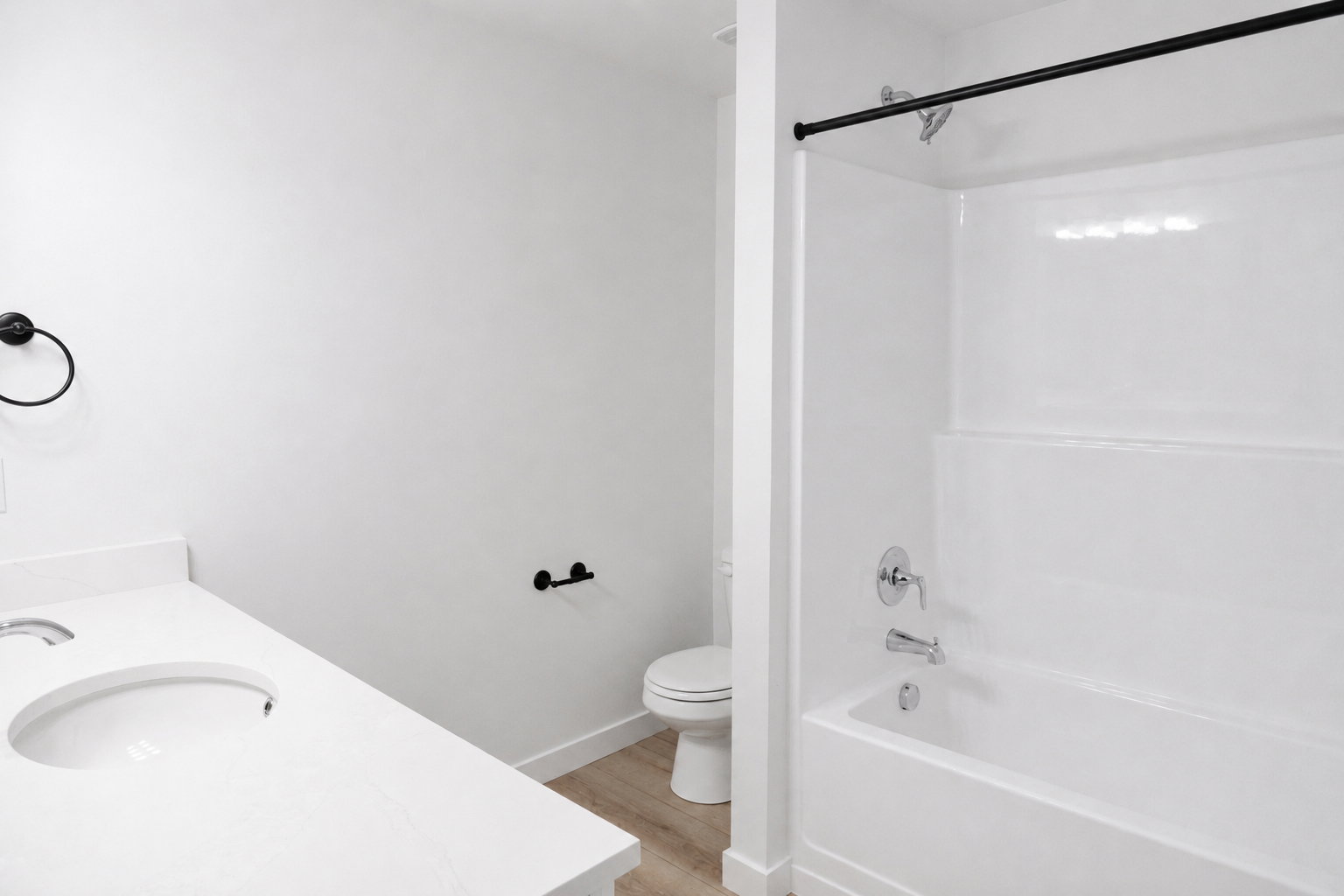 Upstairs bathroom featuring a single vanity with an integrated sink and a quartz countertop.