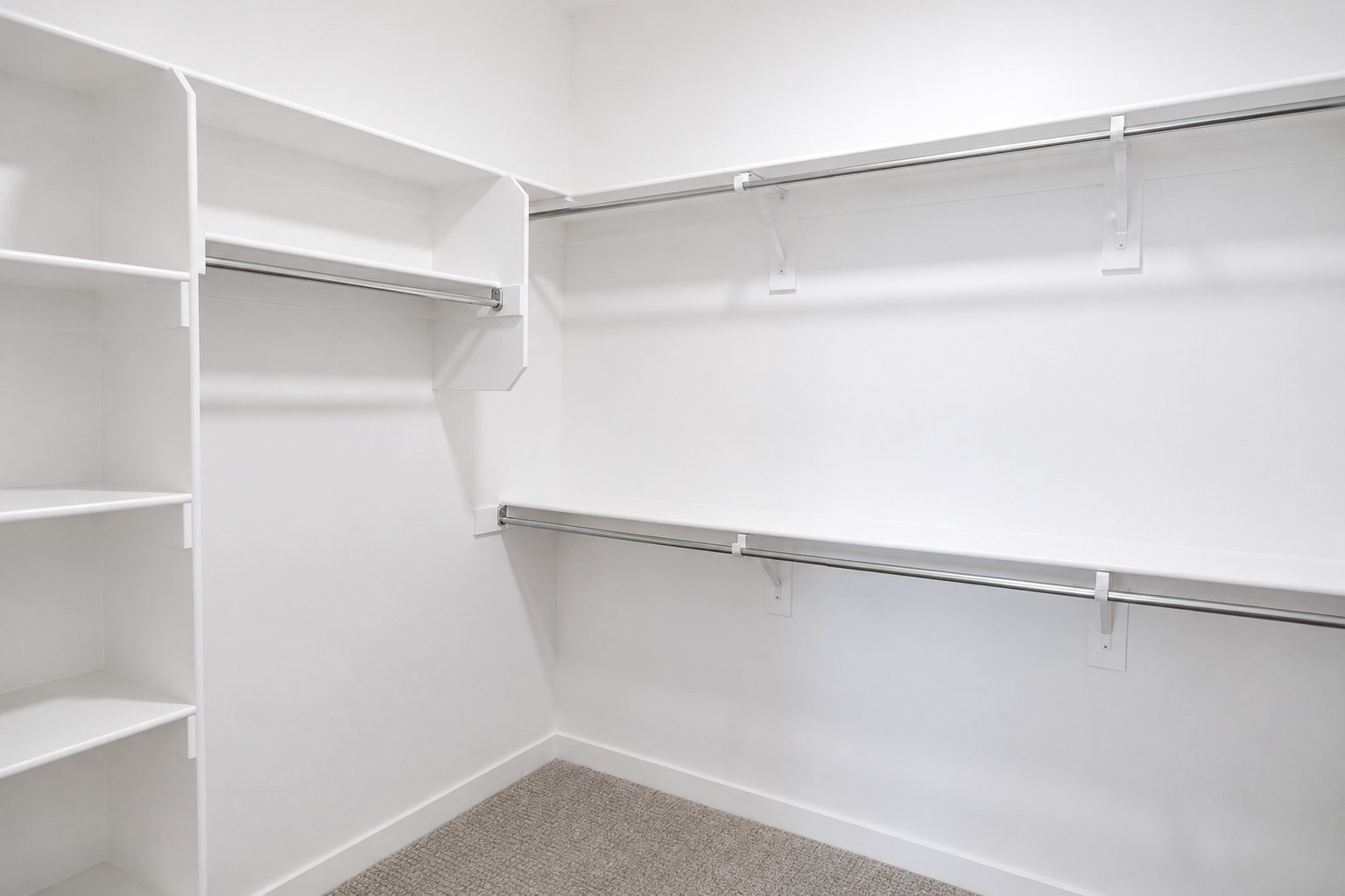 Primary walk-in closet featuring white built-in shelving, chrome hanging rods, and light brown carpet