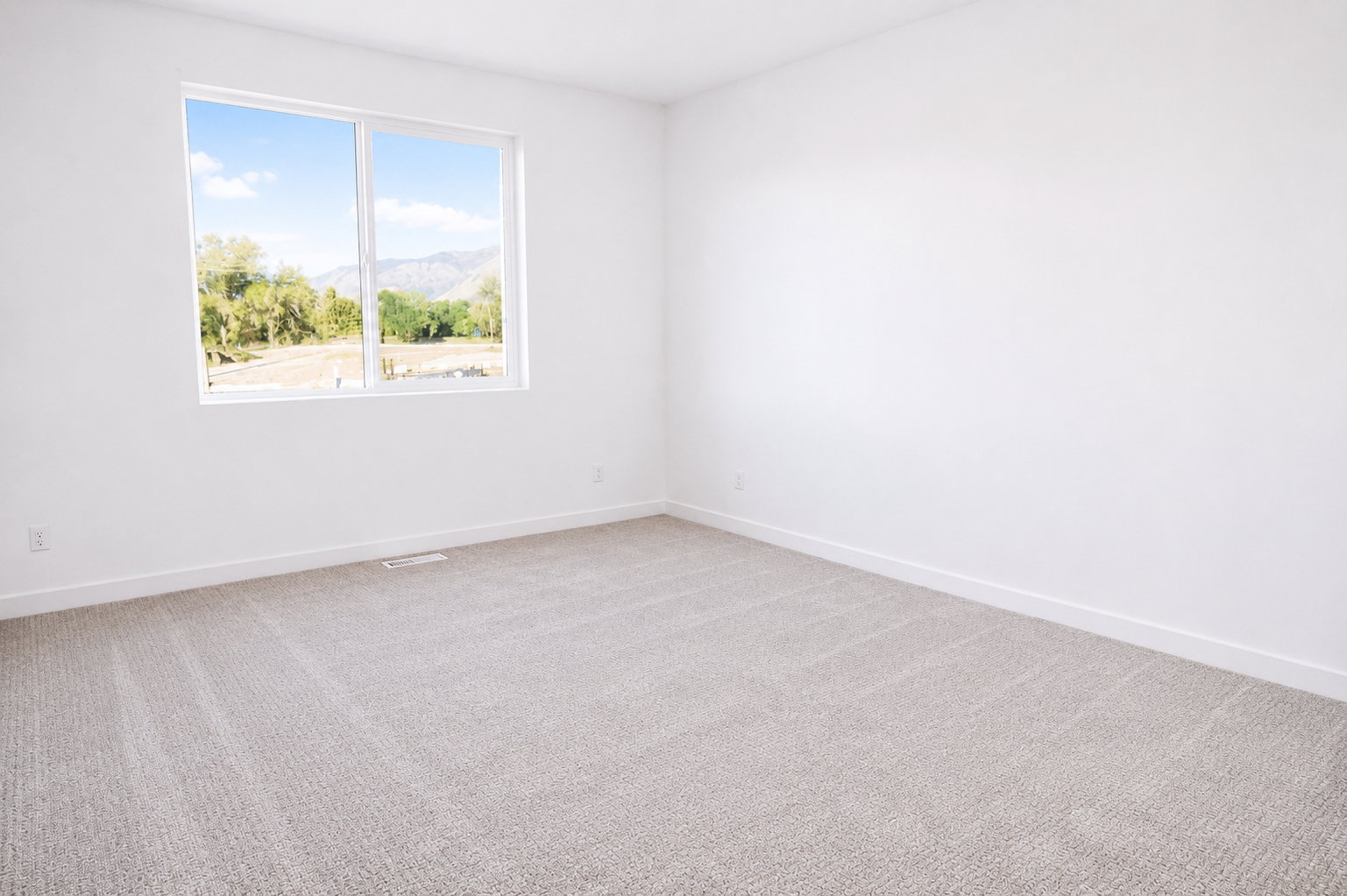 Primary bedroom featuring a large window, plush carpet flooring, white walls, and white baseboards