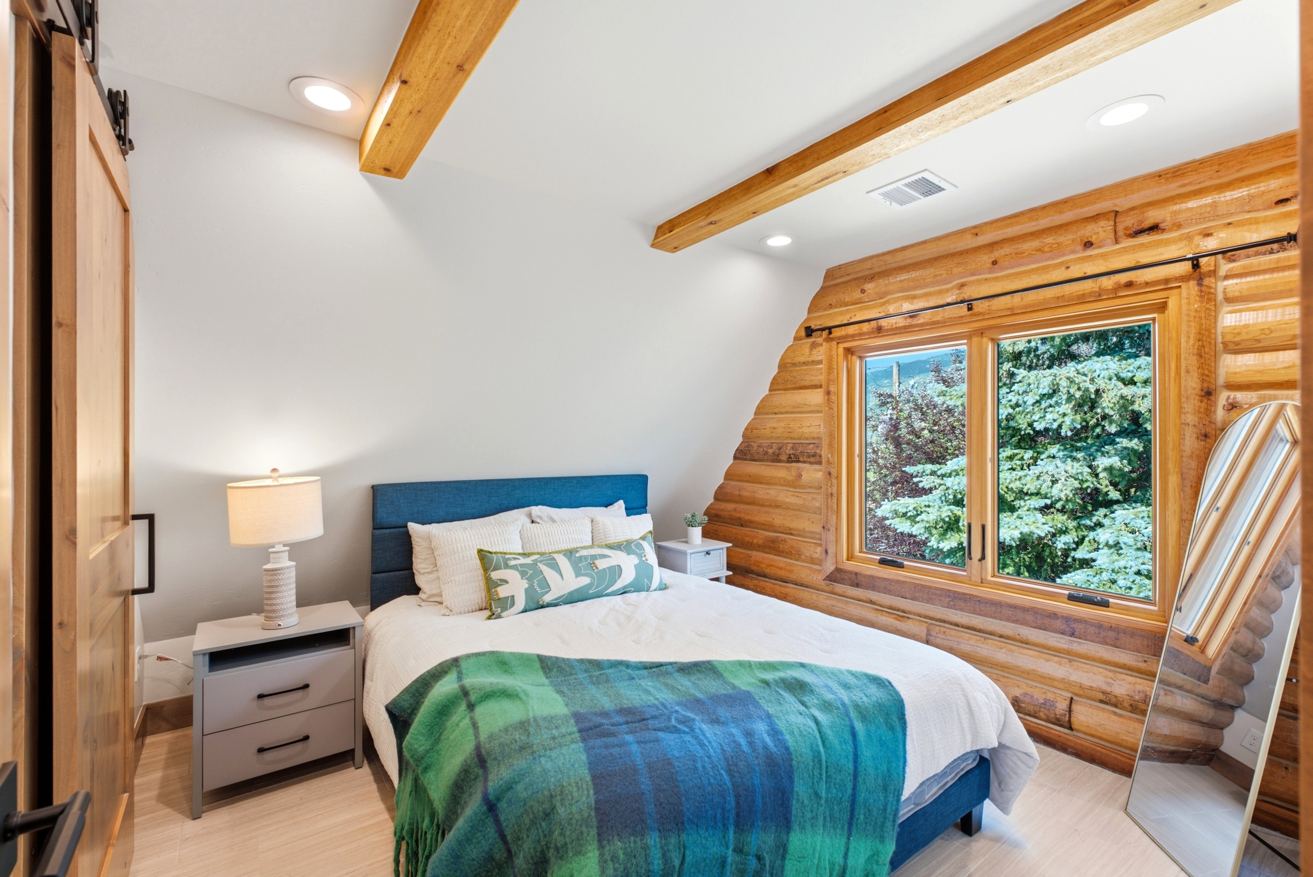 Log-style accent wall with a large window