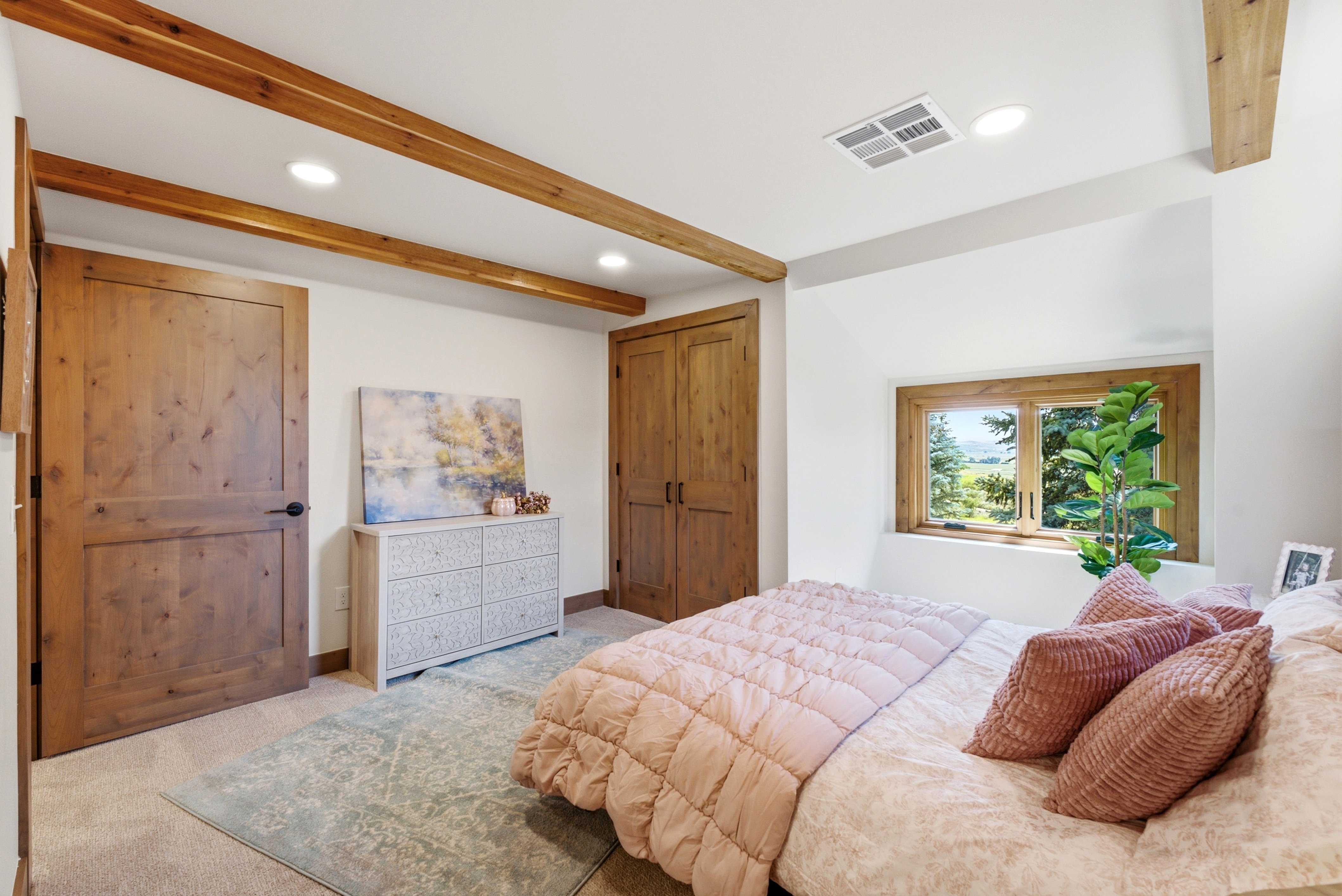 Room featuring exposed wood ceiling beams and recessed lighting