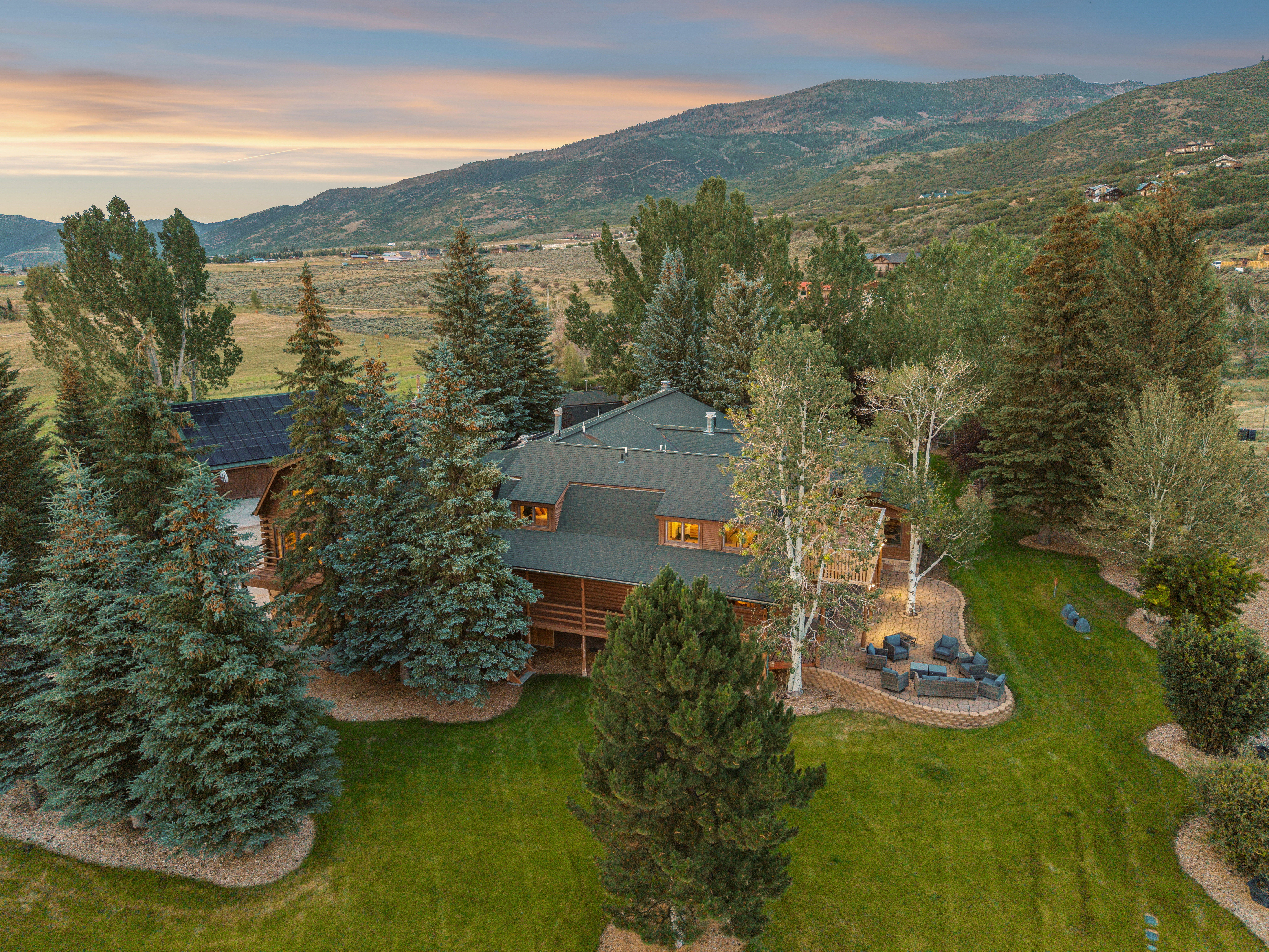 Spacious property featuring a large timber-clad residence with a multi-level roofline