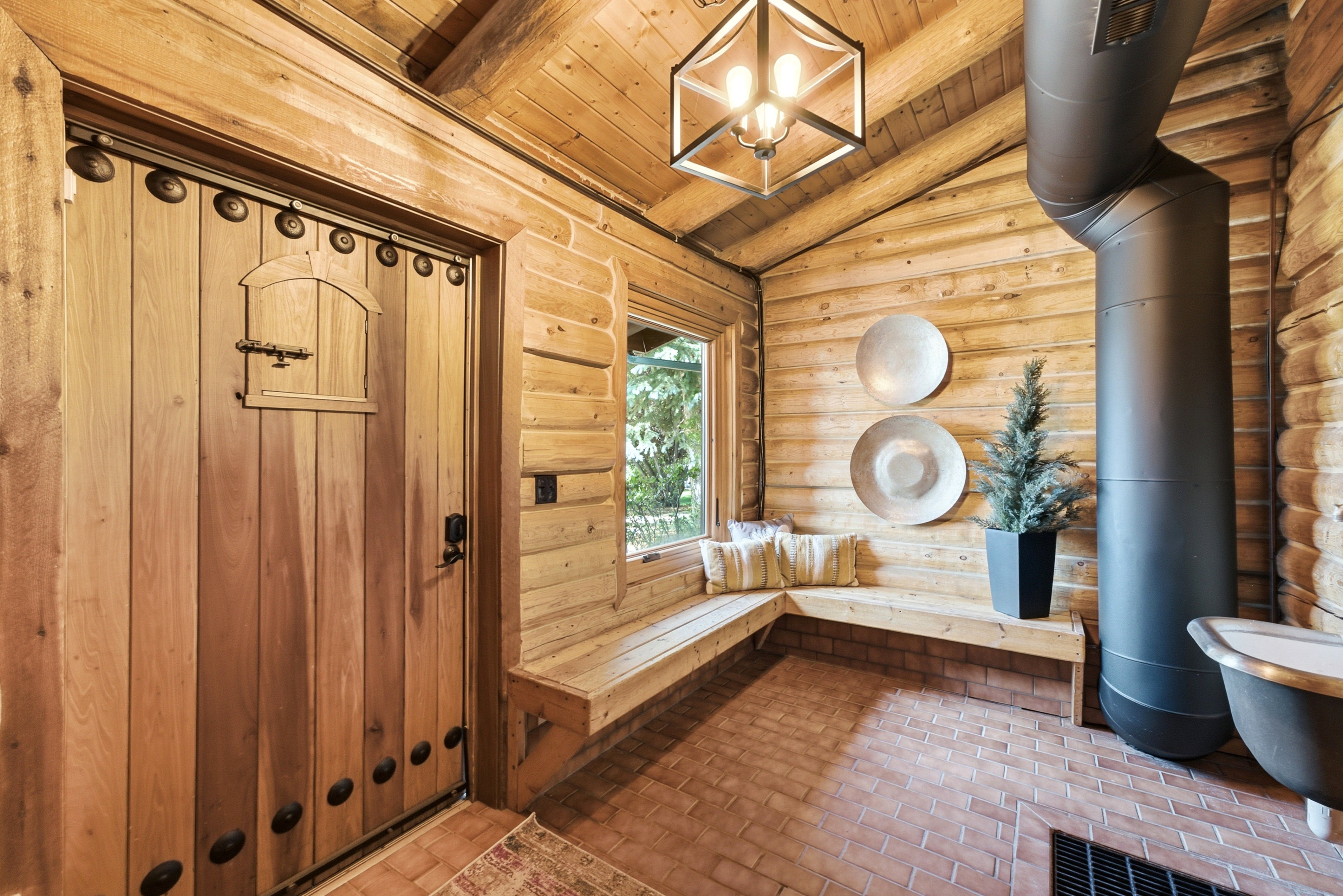 Rustic entryway featuring a solid wood door with decorative hardware