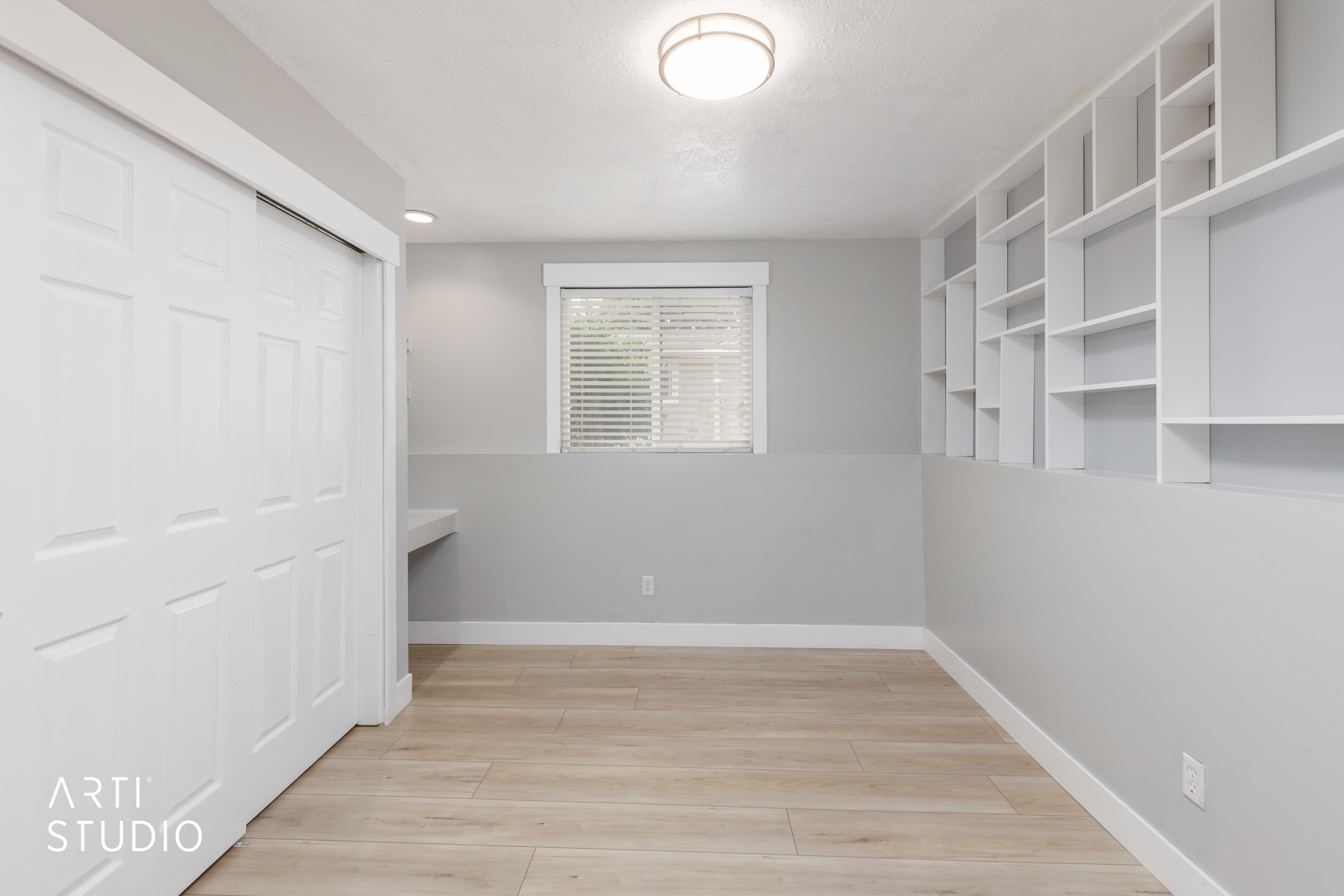 Light wood-finish flooring complements the neutral wall tones