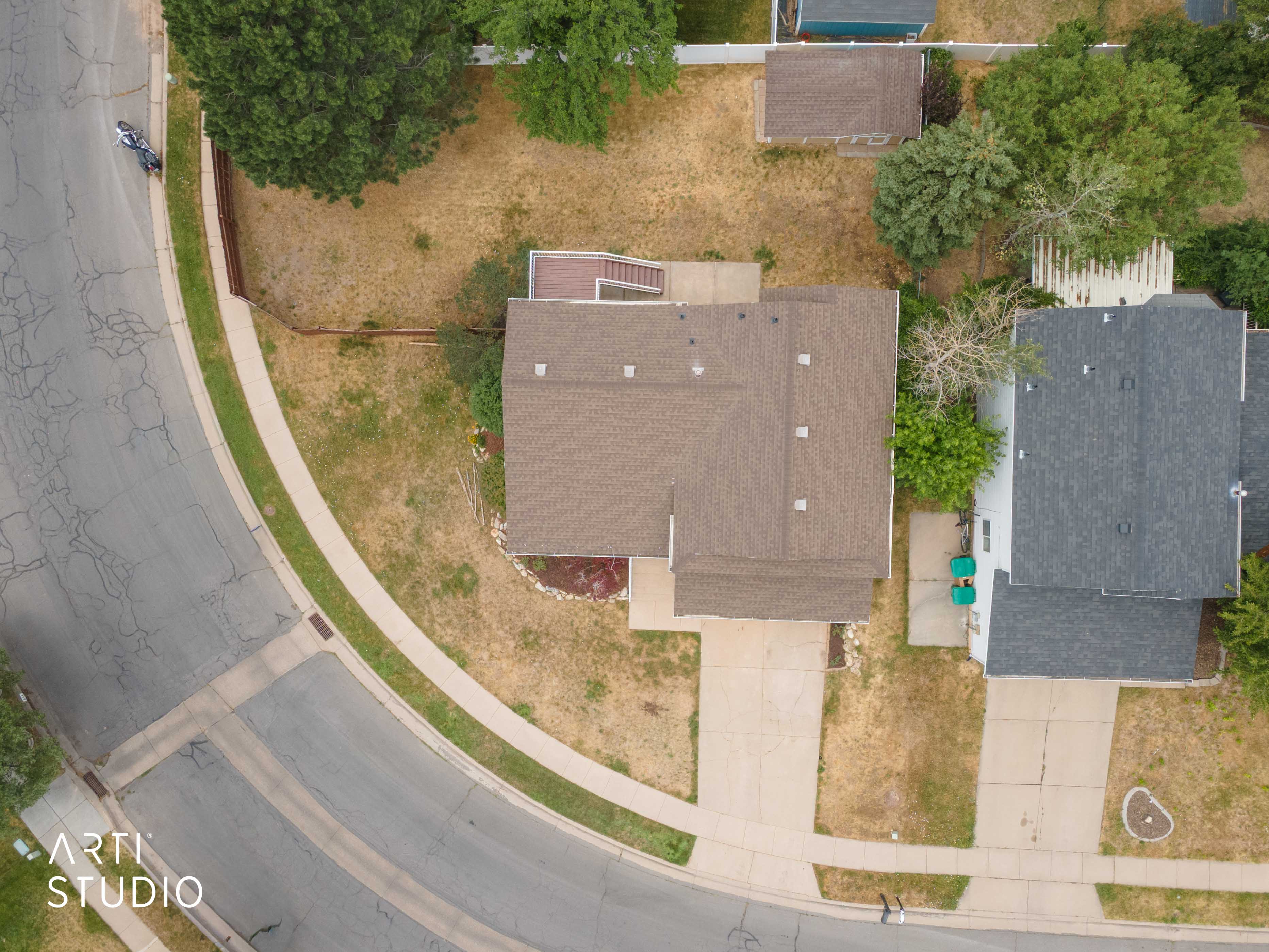 Asphalt shingle roof, concrete driveway, and a rear deck