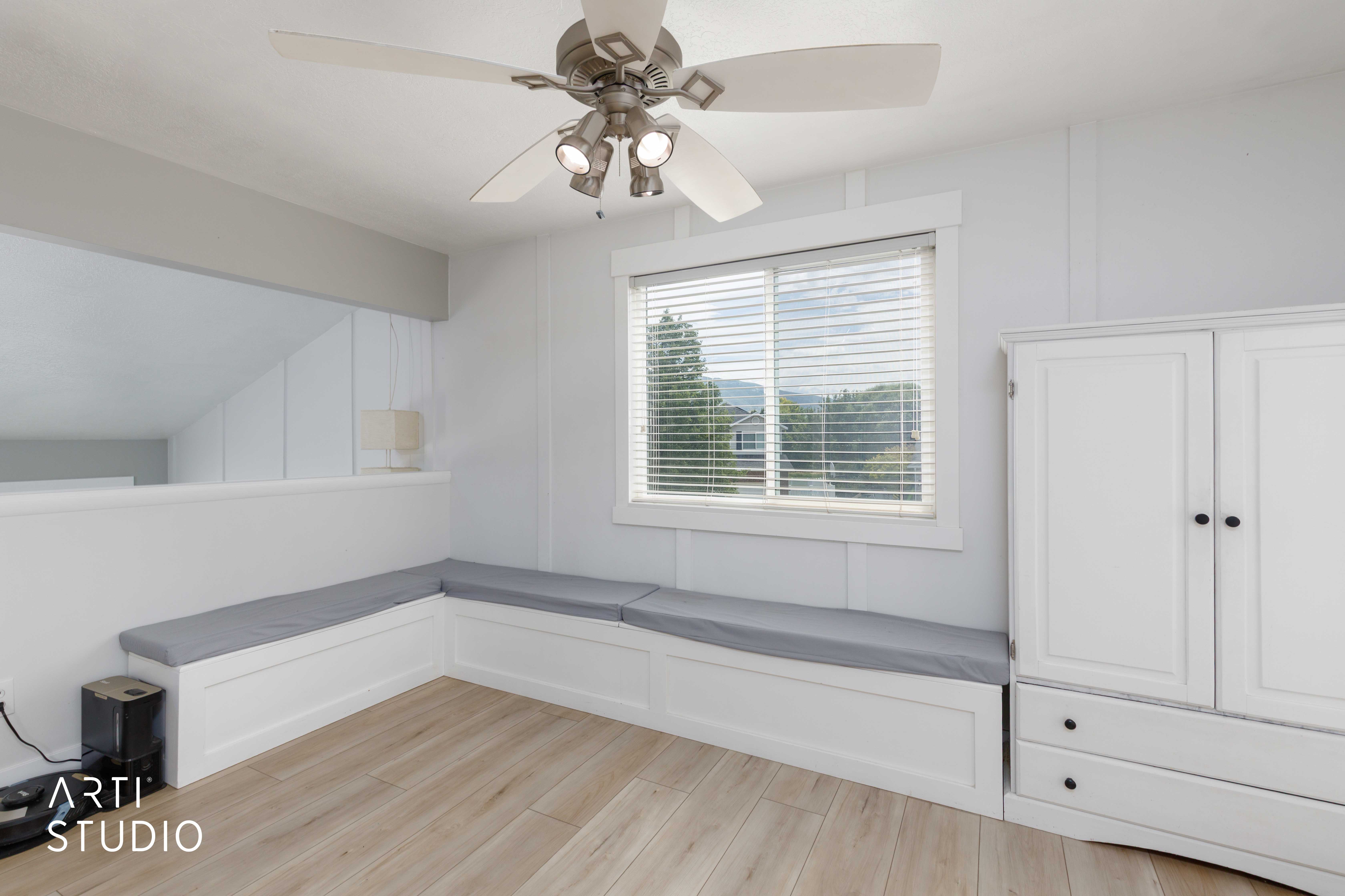 Light wood-finish flooring with a ceiling fan featuring integrated lighting