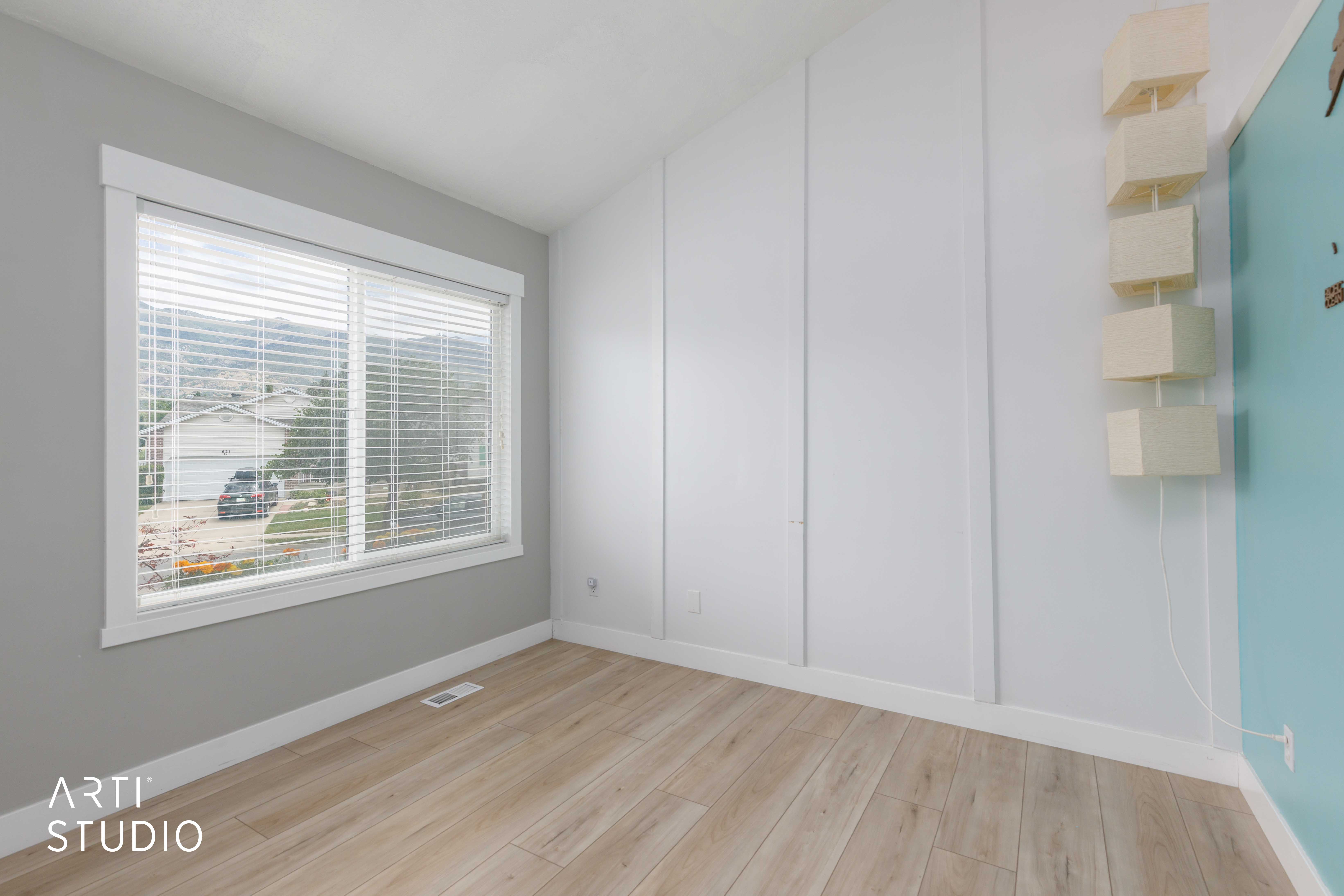 Light wood-finish flooring with a white baseboard trim
