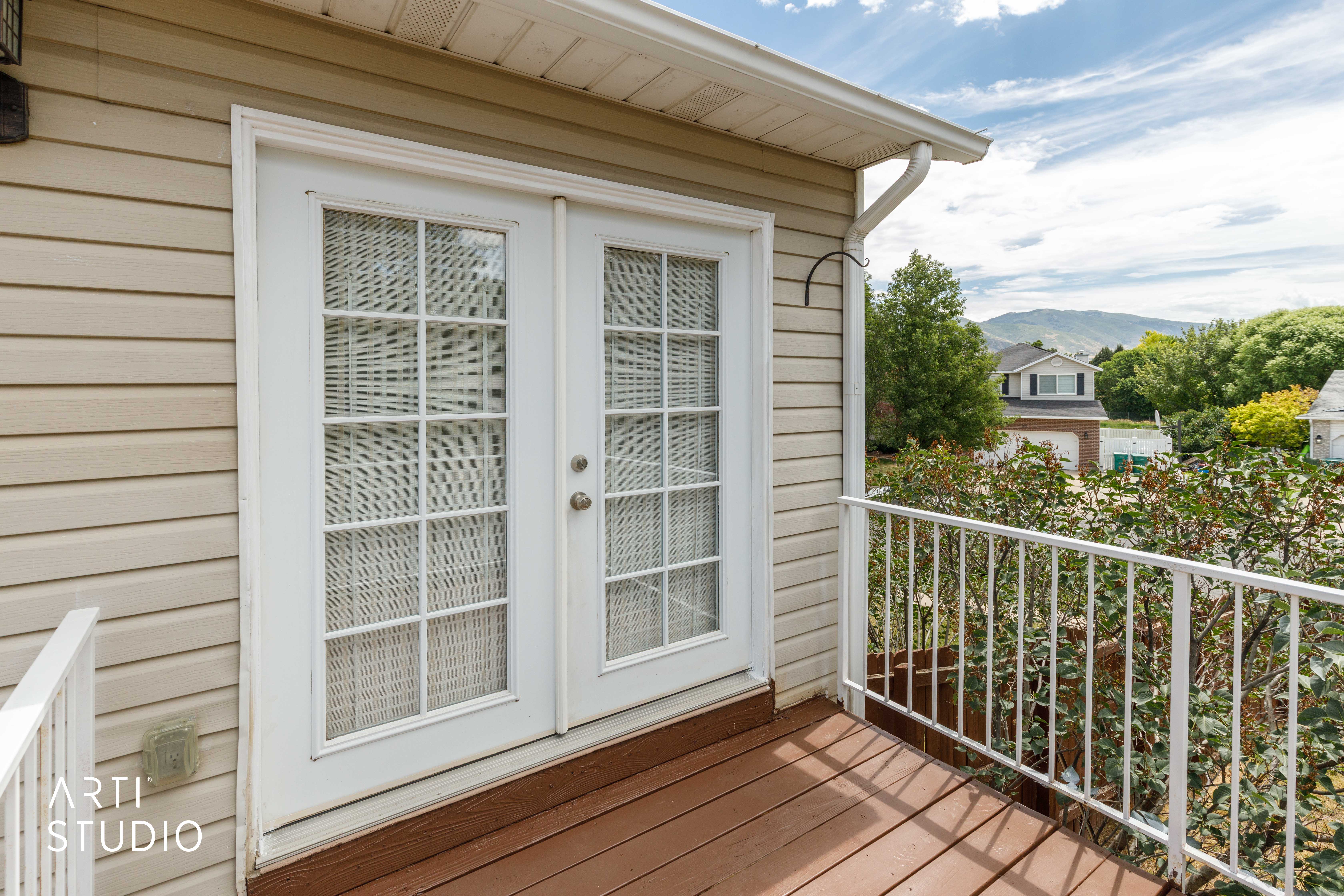 Balcony with French doors and white grid-patterned windows