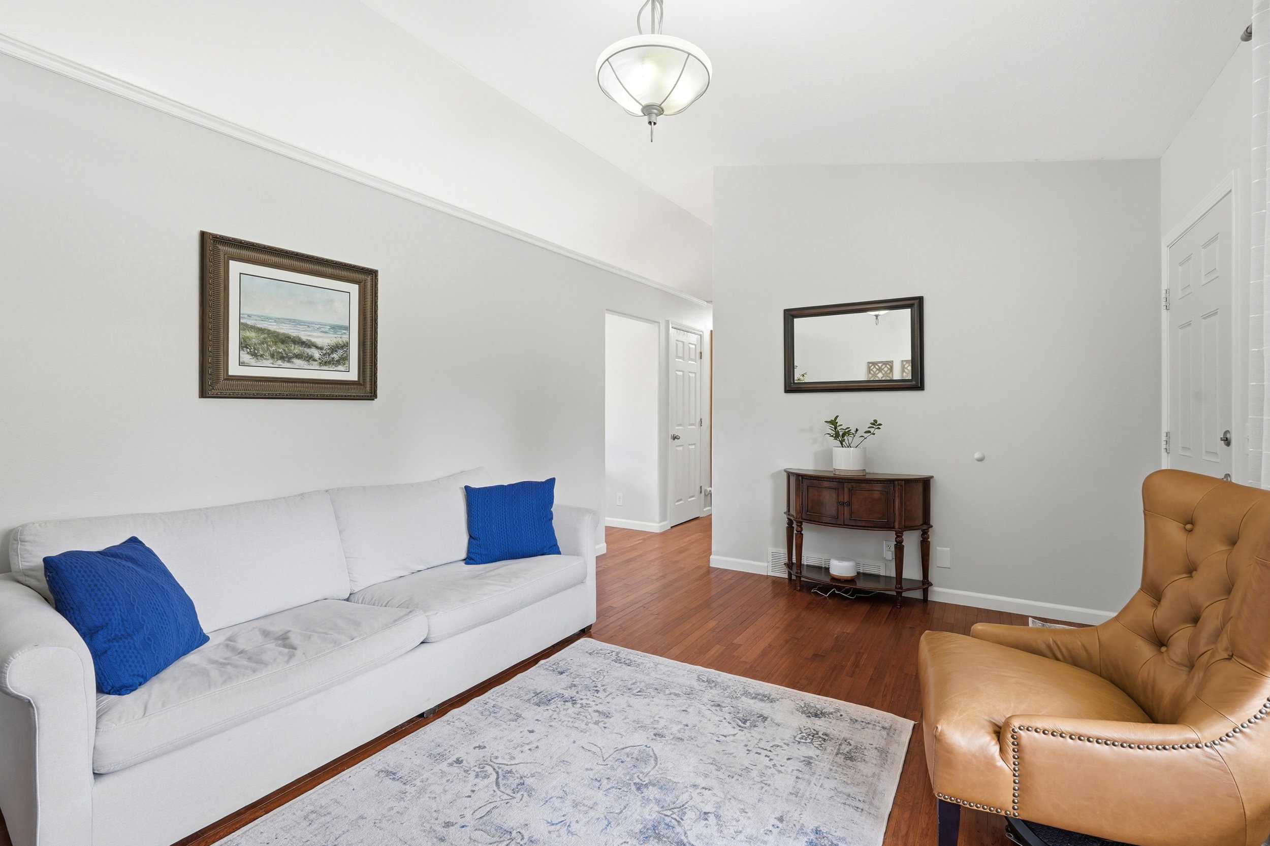 Vaulted ceilings enhance this space featuring rich wood-finish flooring
