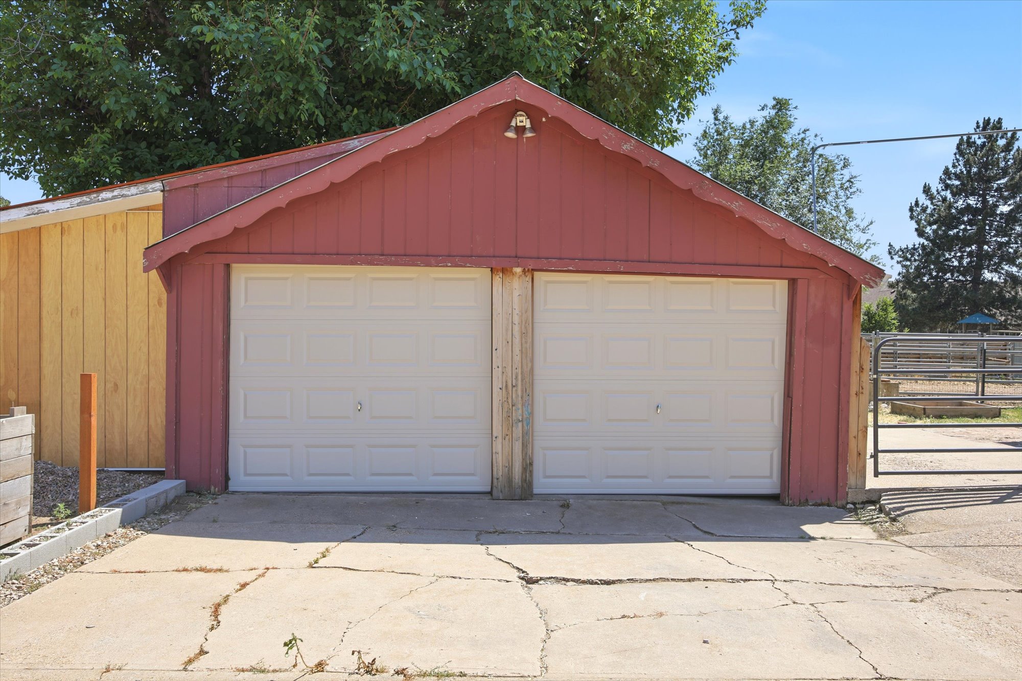 Two-car garage structure with new white paneled garage doors
