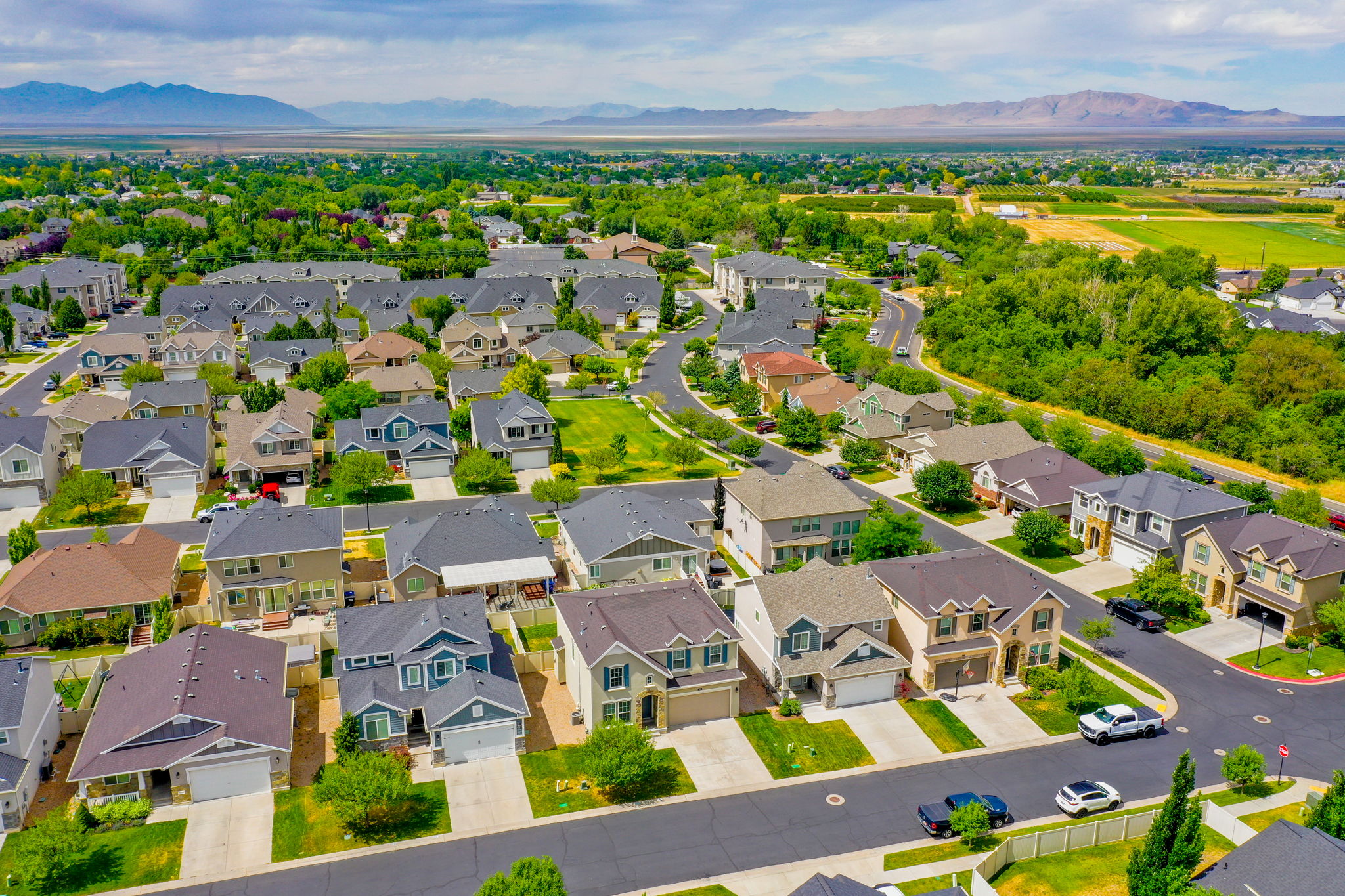 Expansive residential area featuring numerous single-family homes, mature landscaping, and curved streets