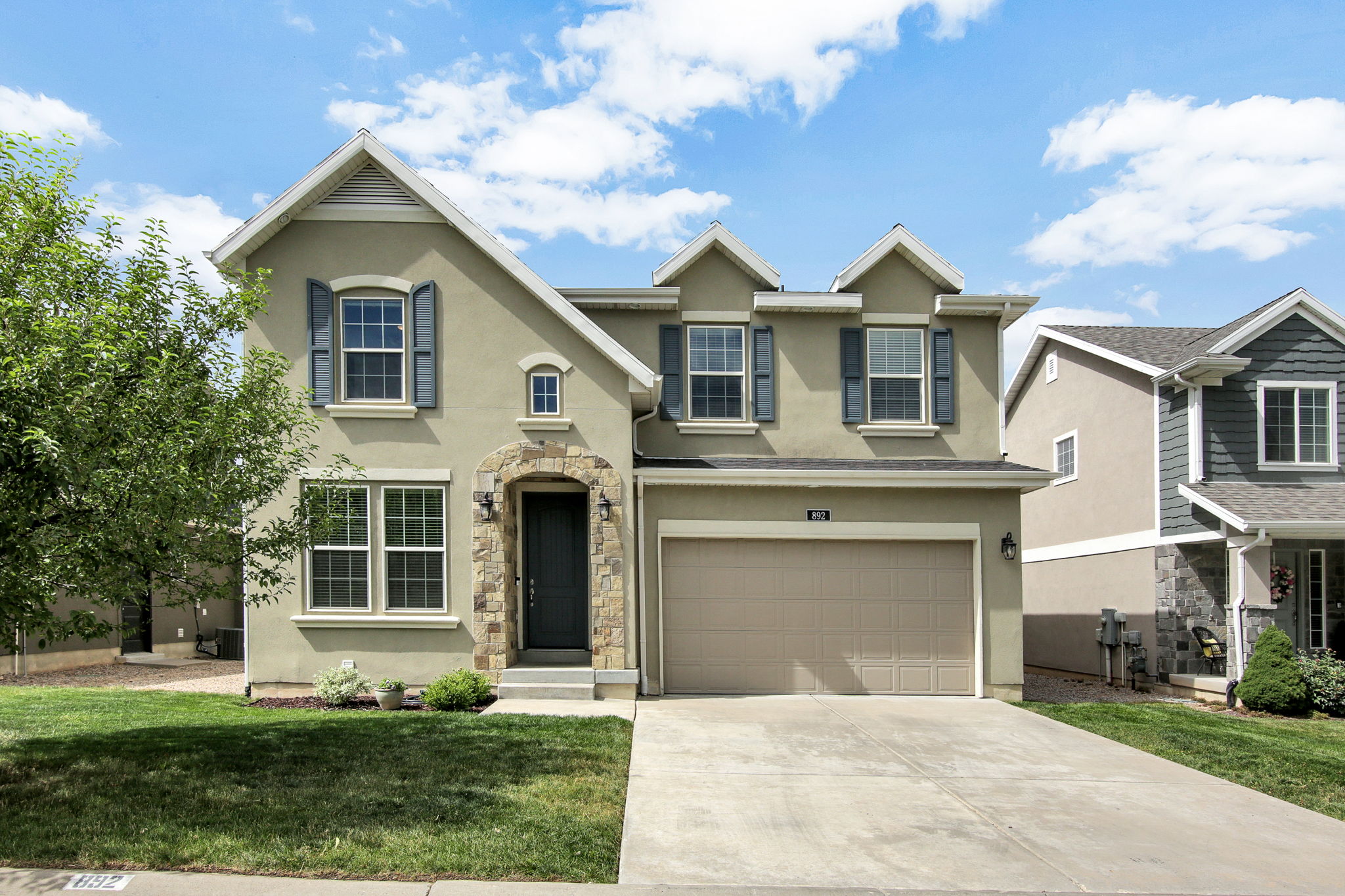 Stucco exterior with stone accent archway around the front entry