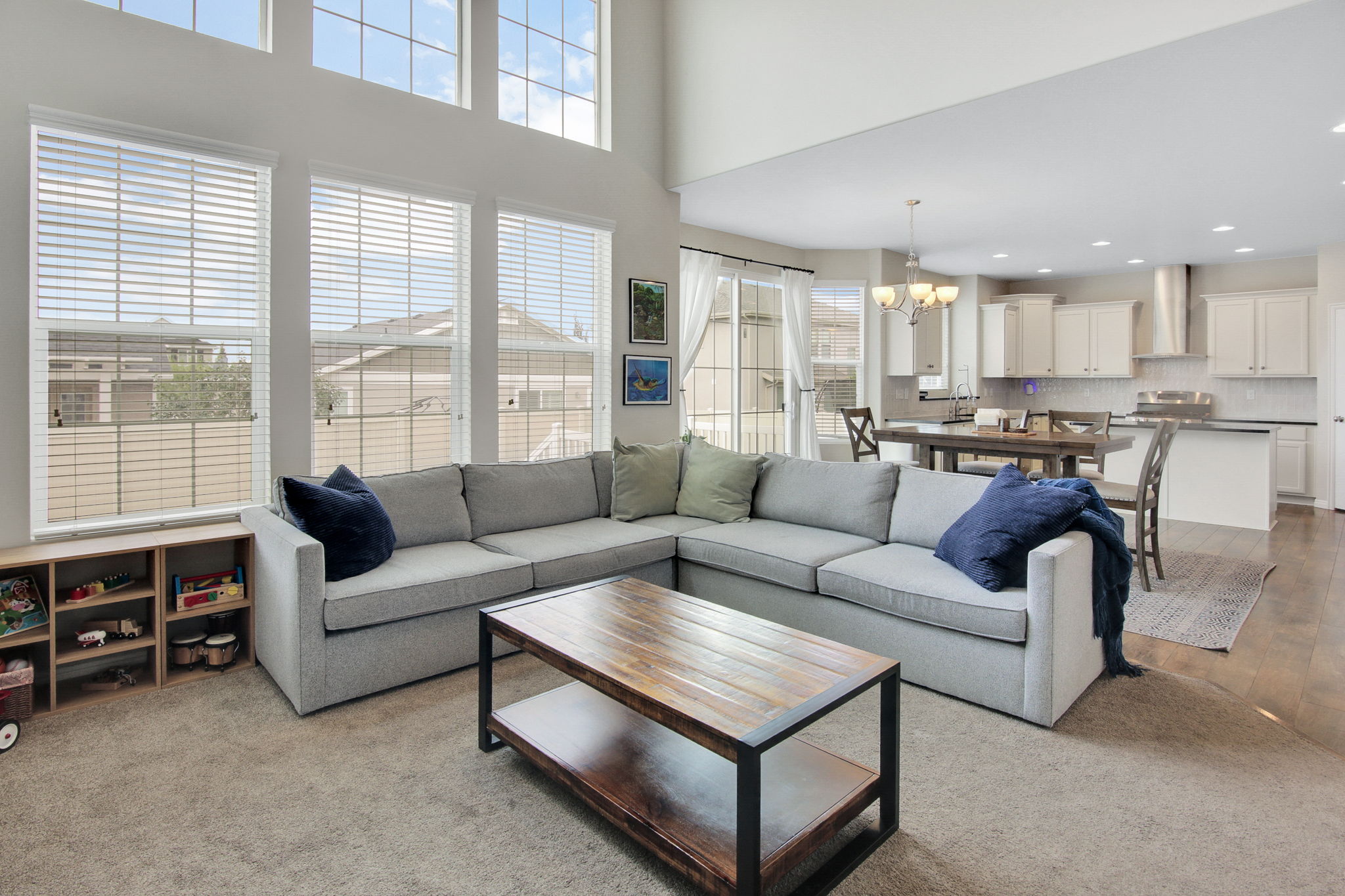 Open-concept living space featuring high ceilings and abundant natural light