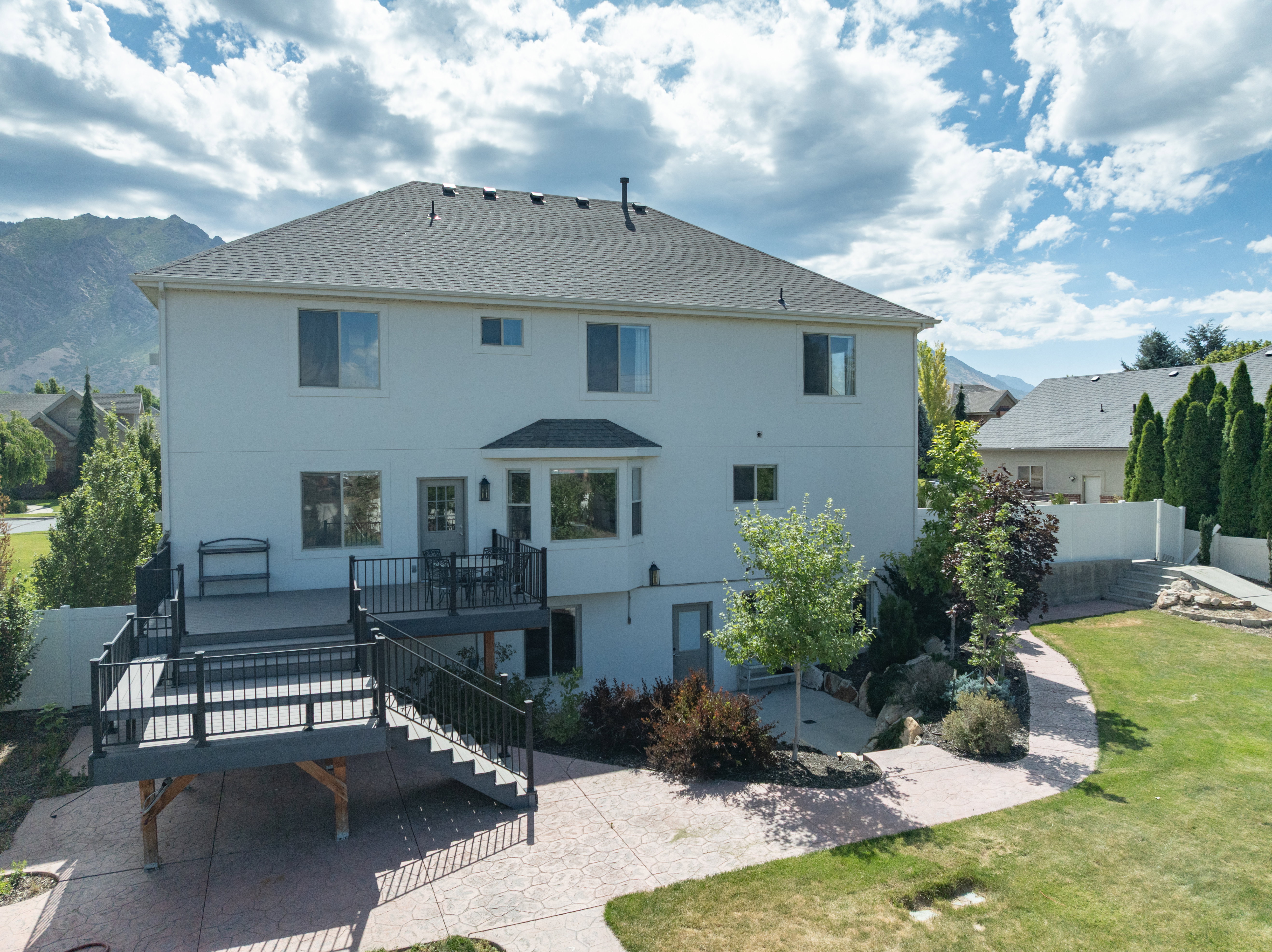 Multi-level deck with black railings and stairs, providing outdoor living space