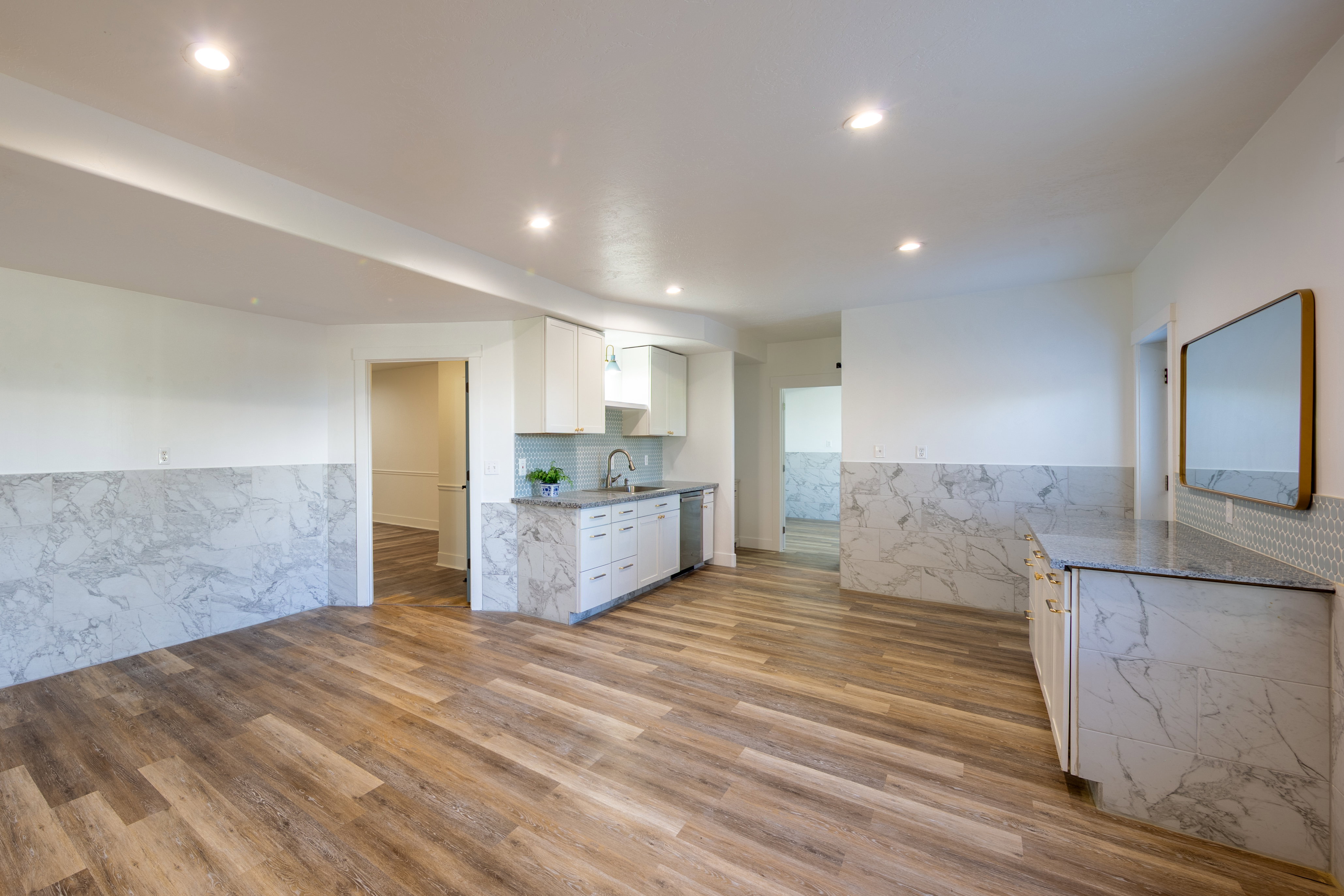 Open-concept space featuring wood-finish flooring, recessed lighting, and white walls