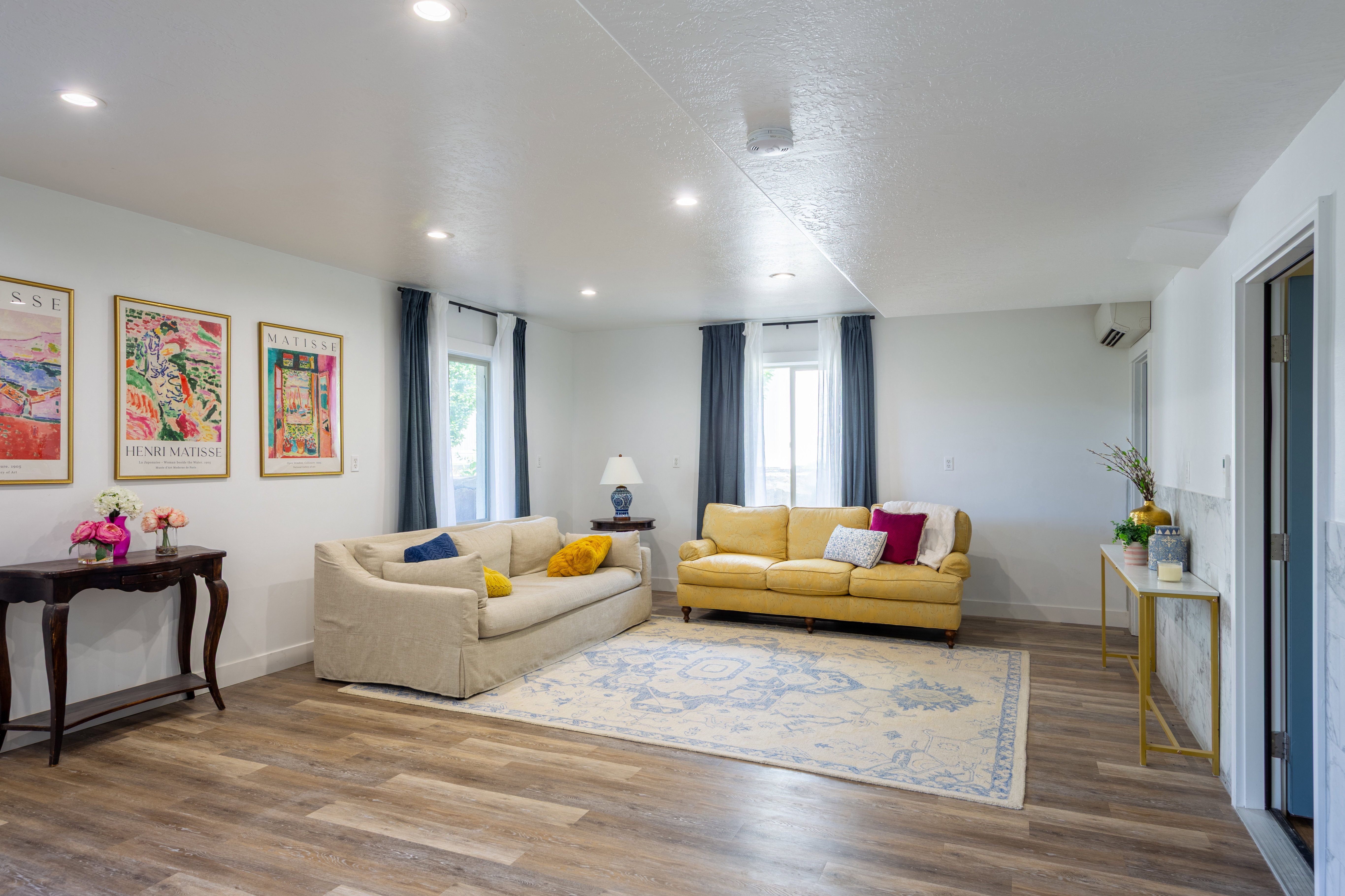 Spacious interior featuring wood-finish flooring, recessed lighting, and white walls