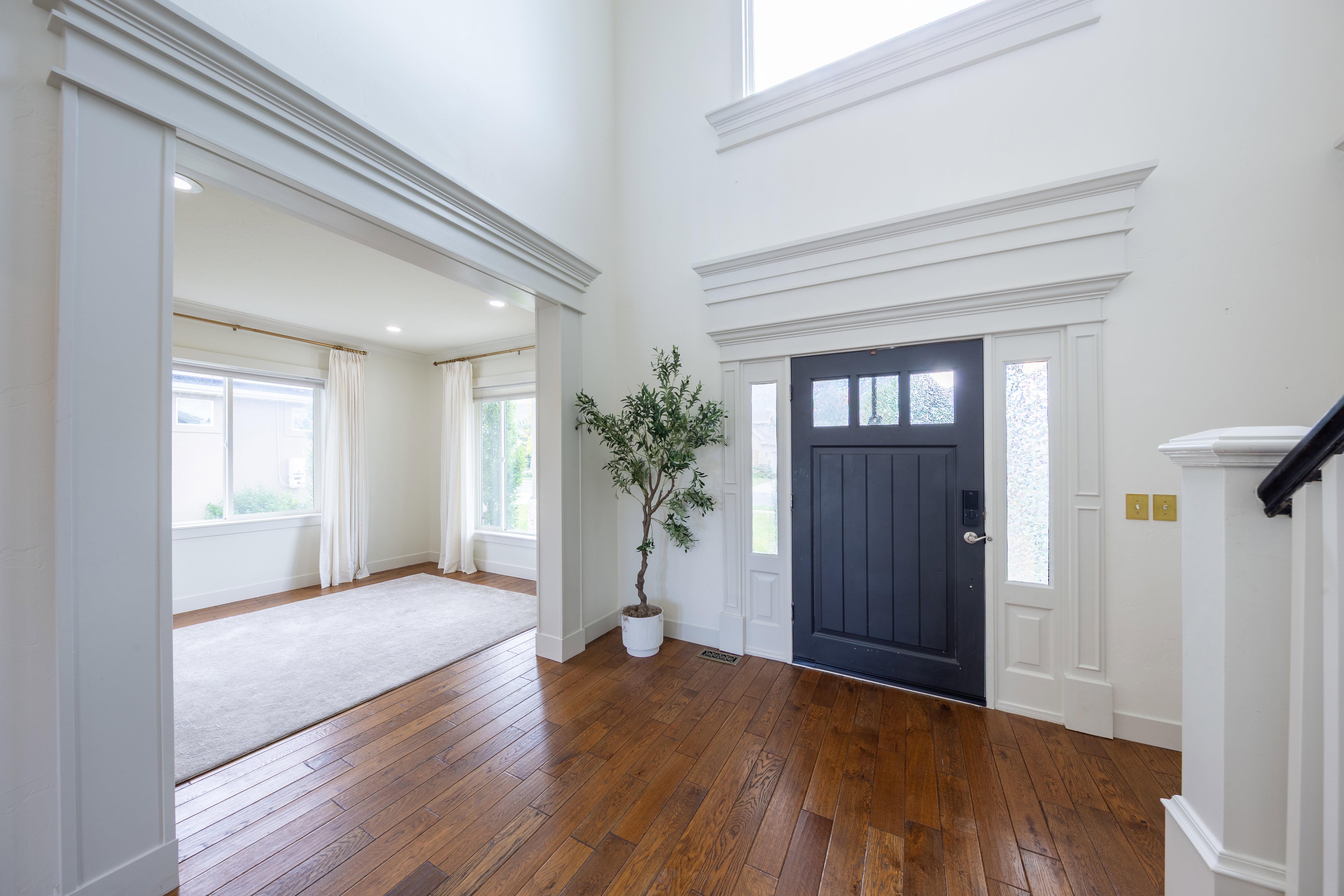 Grand entryway featuring high ceilings and wood-finish flooring