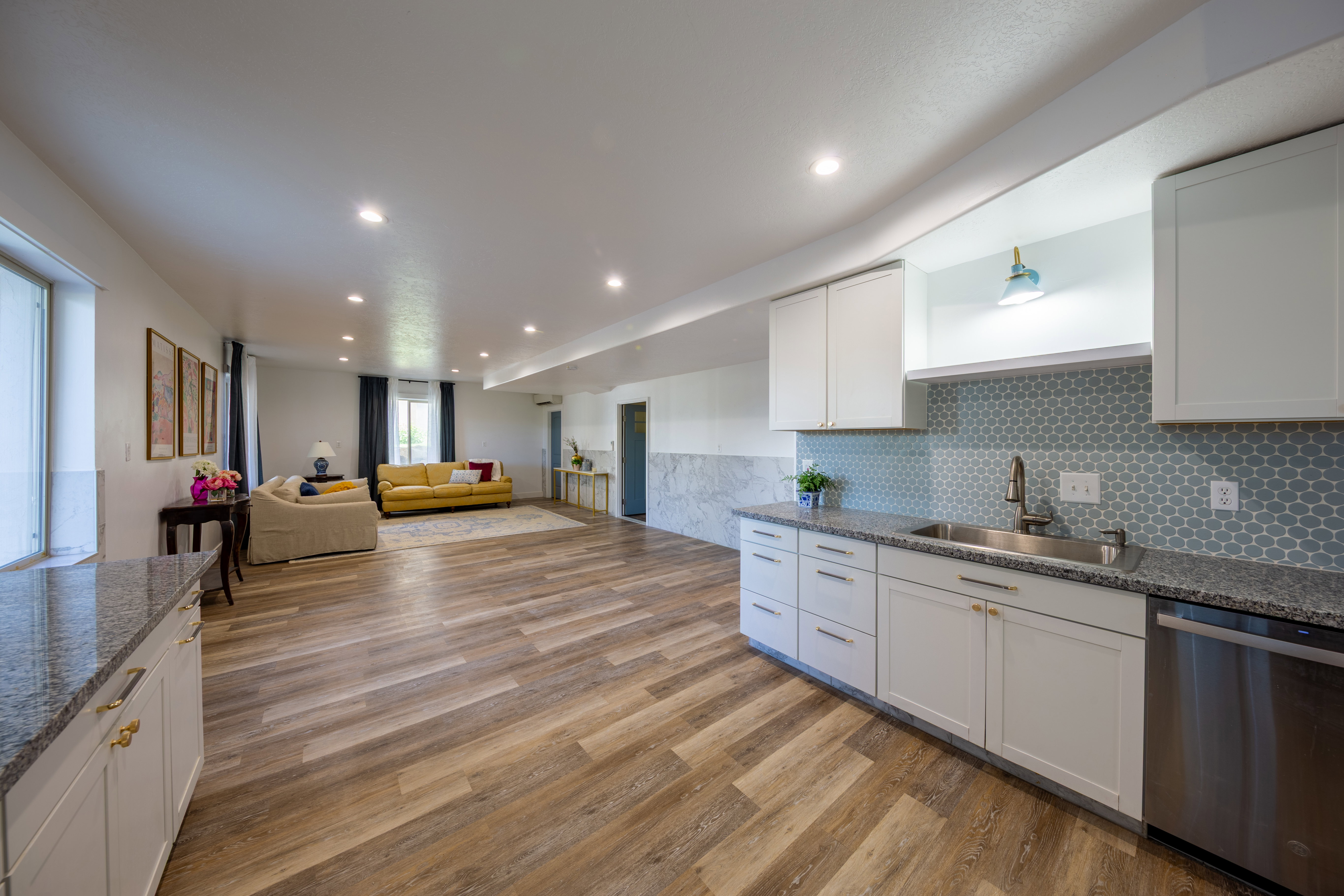 Open concept lower level featuring wood-finish flooring, recessed lighting, and a kitchenette