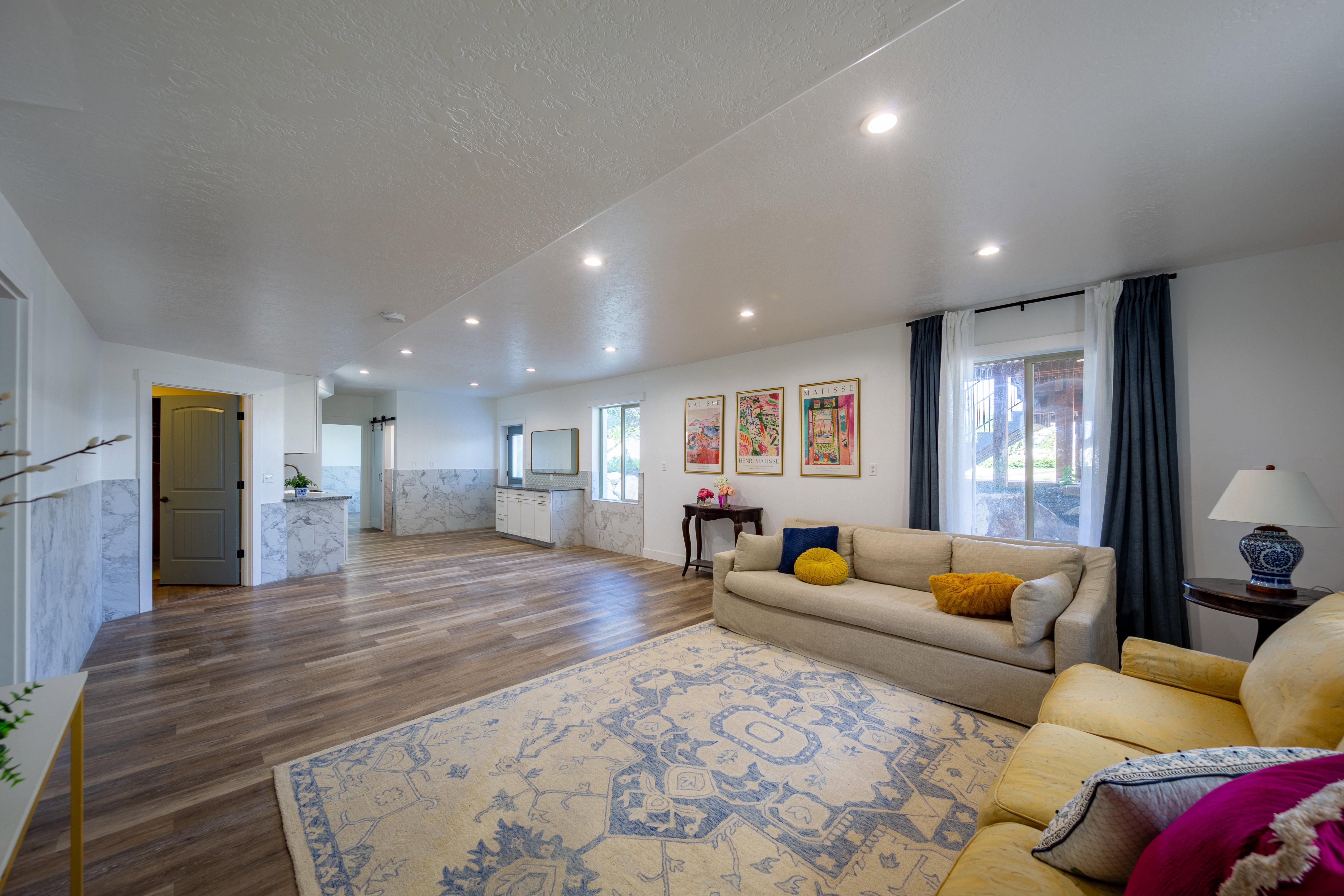 Open-concept living space with wood-finish flooring and recessed lighting