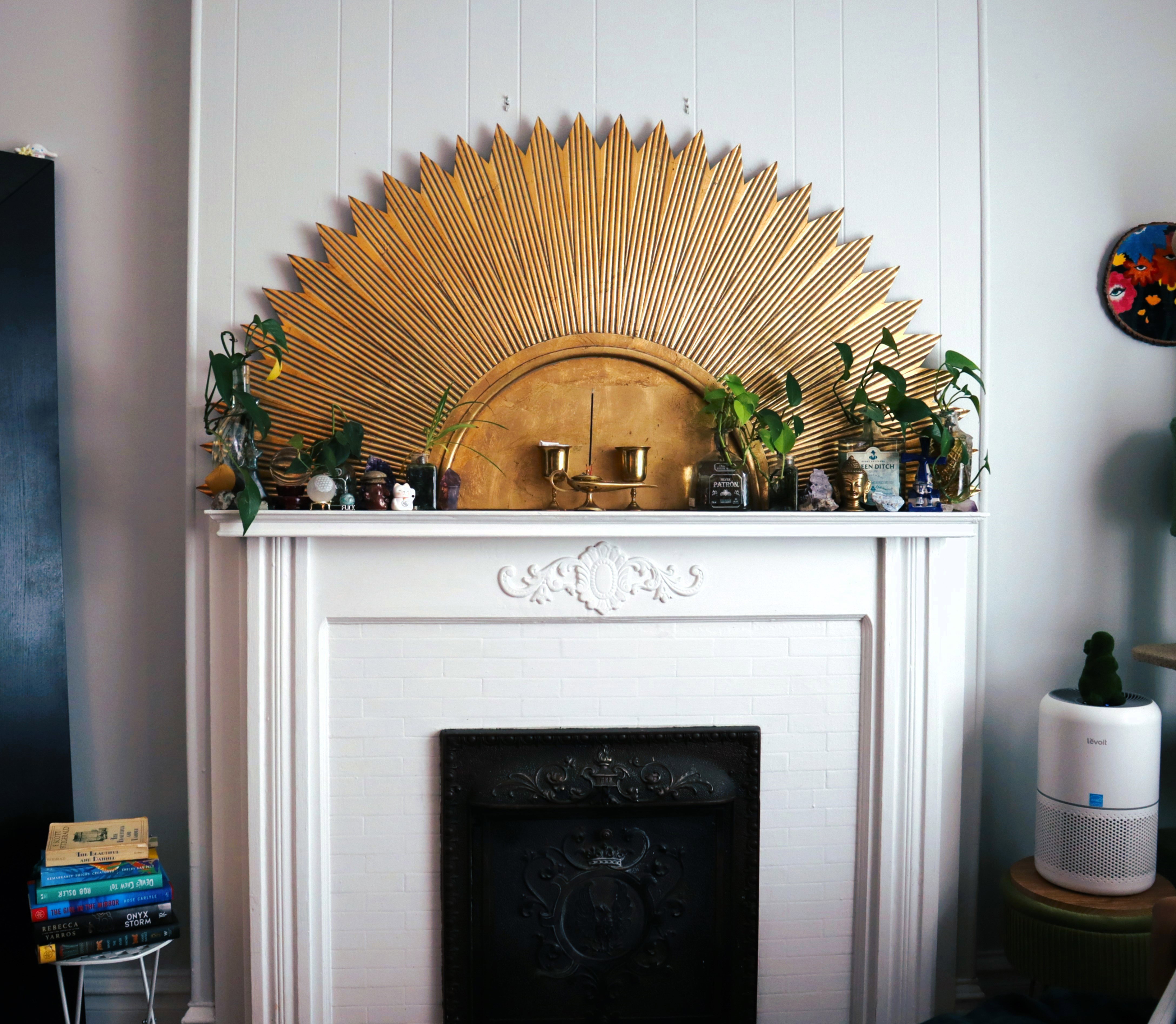 White wood-paneled wall featuring a fireplace with a decorative mantel and an ornate cast iron firebox