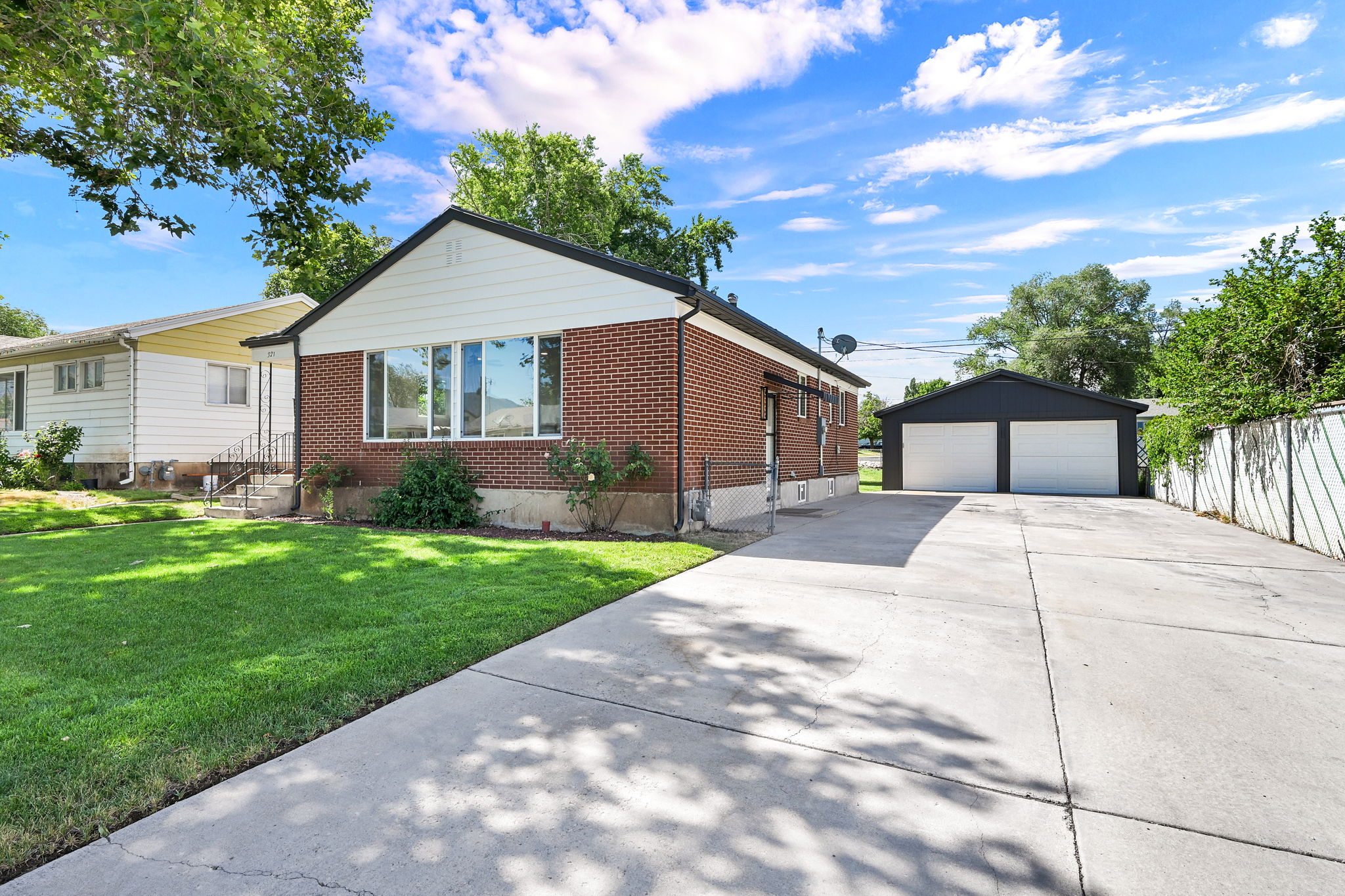 Brick exterior with white siding accents and a black roofline