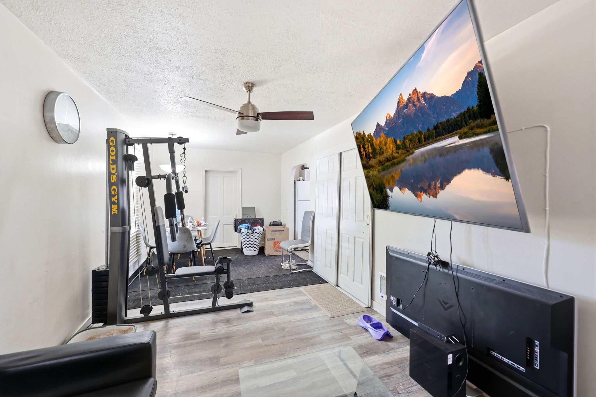 Open concept living space featuring wood-finish flooring and a ceiling fan