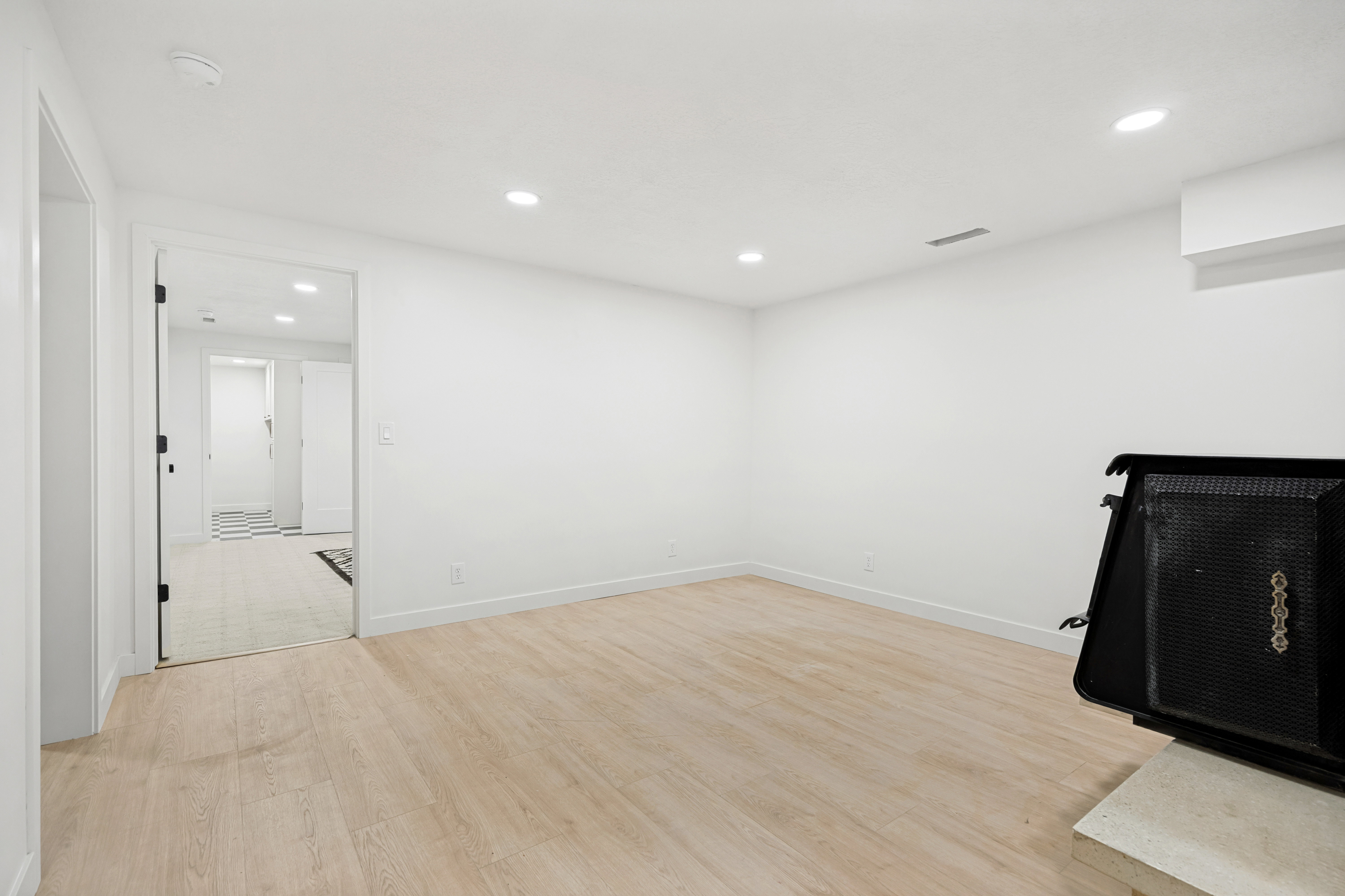 Neutral-toned wood-finish flooring complements crisp white walls