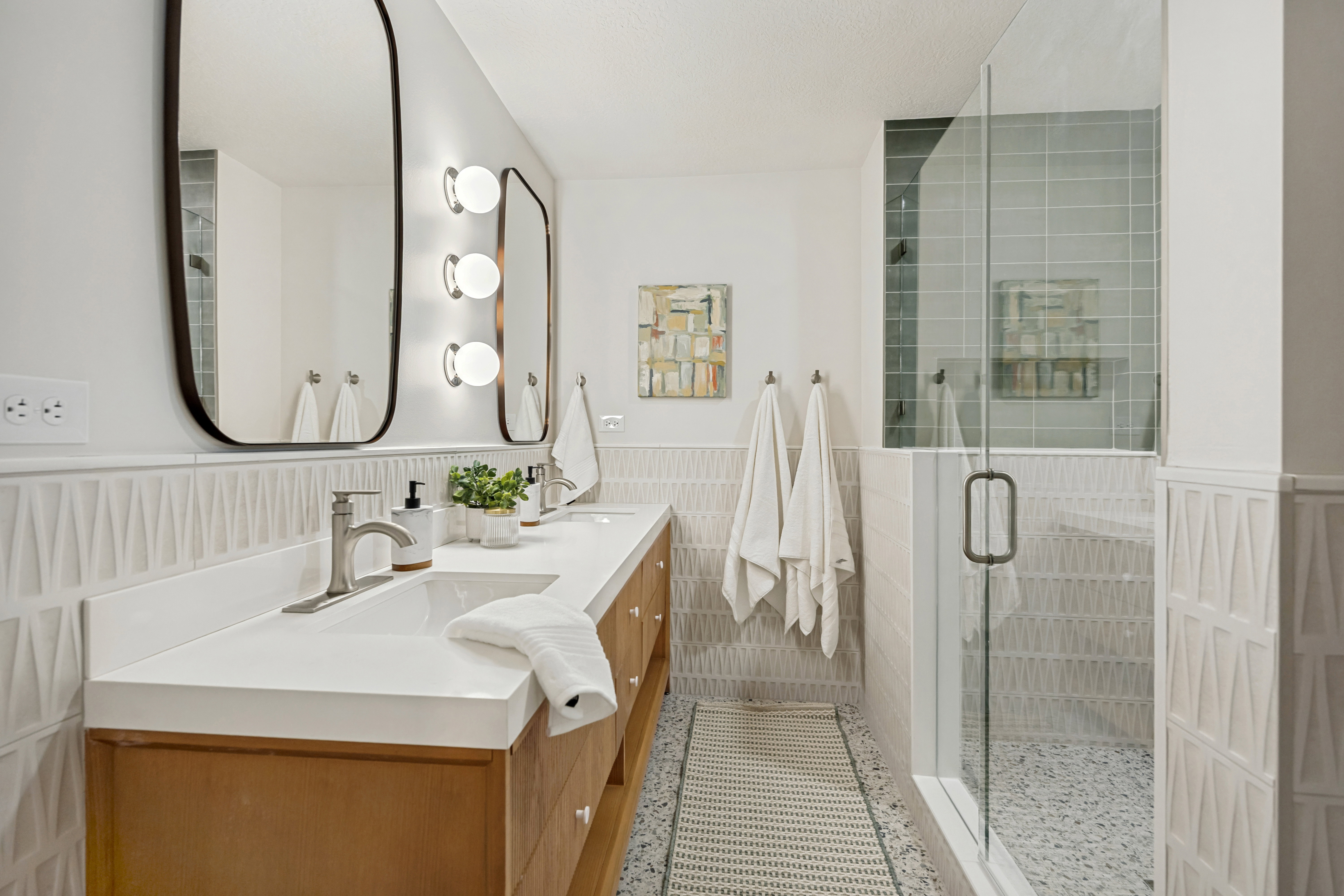 Double vanity with undermount sinks and wood-finish cabinetry