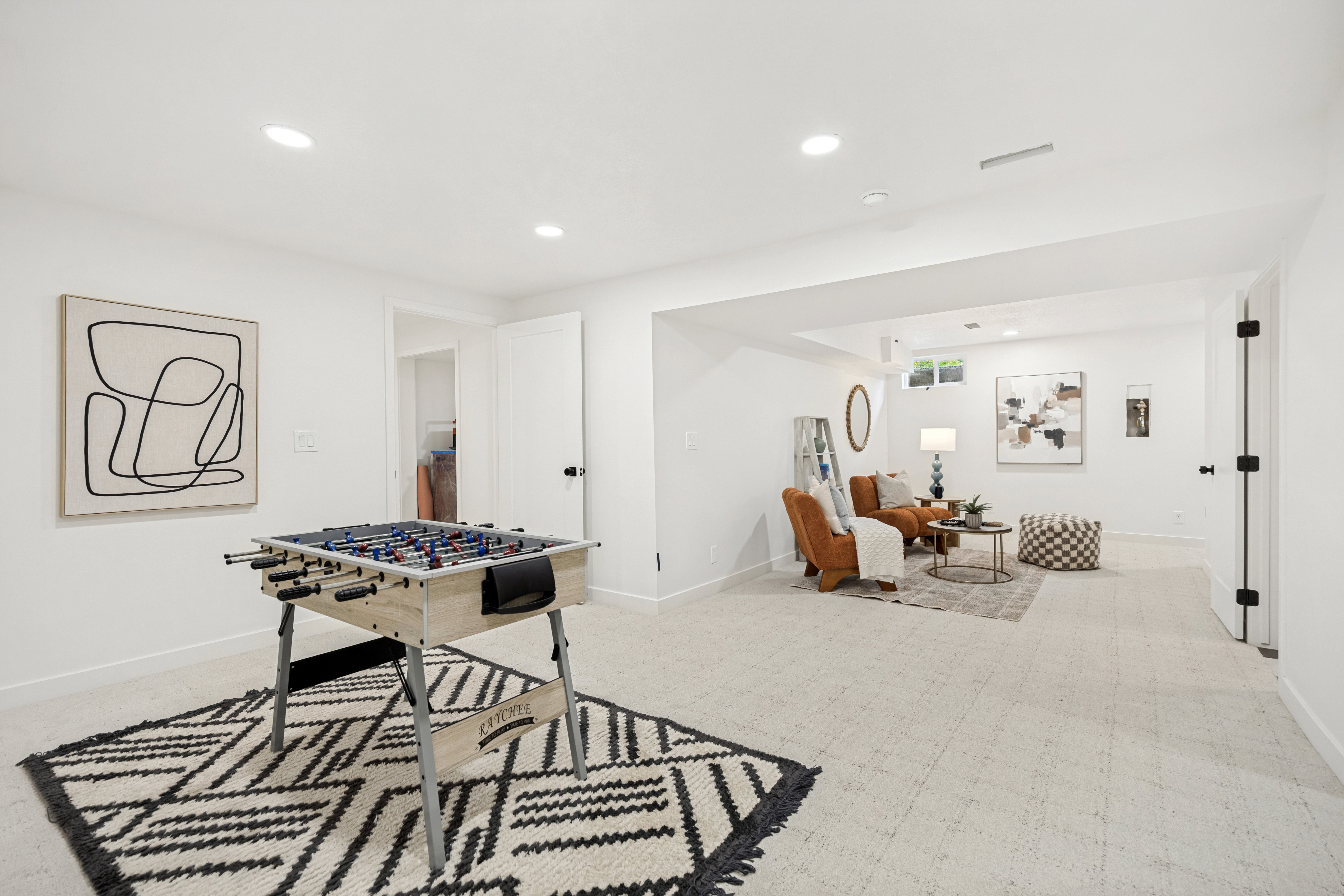 Spacious finished lower level featuring recessed lighting, light-toned carpeting, white walls, and a window for natural illumination