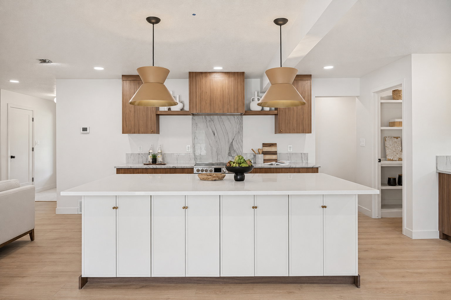 Kitchen featuring a large central island with white cabinetry, wood-finish flooring, recessed lighting, and two pendant light fixtures