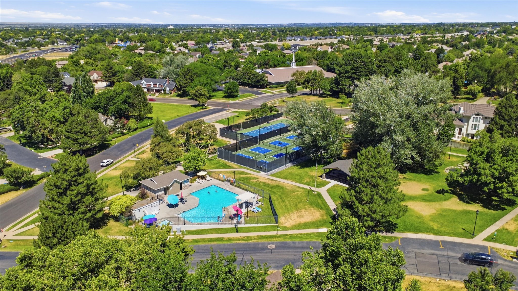 Aerial view of the neighborhood pool, tennis/pickleball courts and playground.