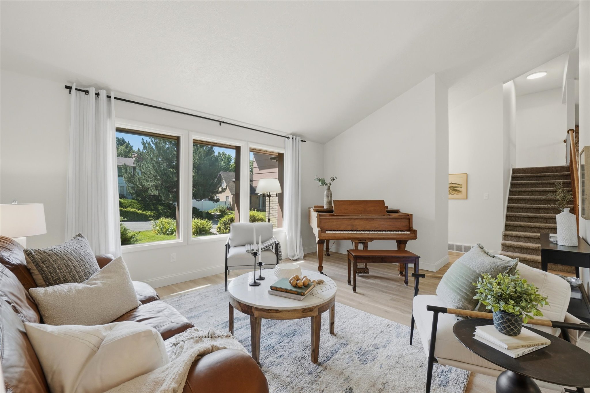 Light wood-finish flooring complements the neutral wall tones