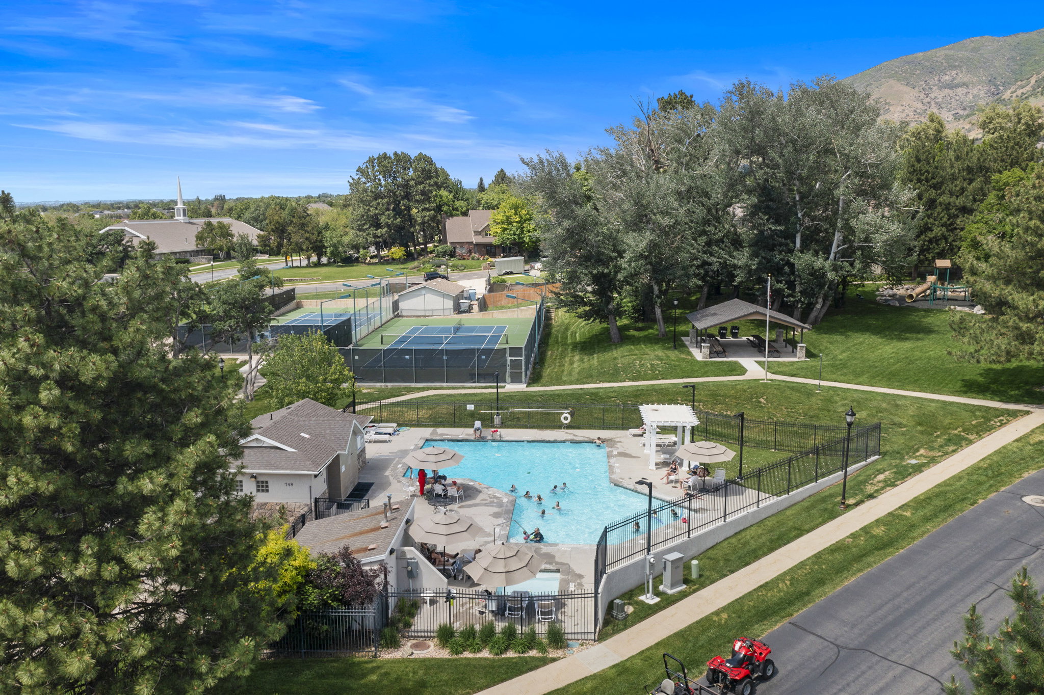 Outdoor community pool featuring a shallow entry and surrounding lounge areas