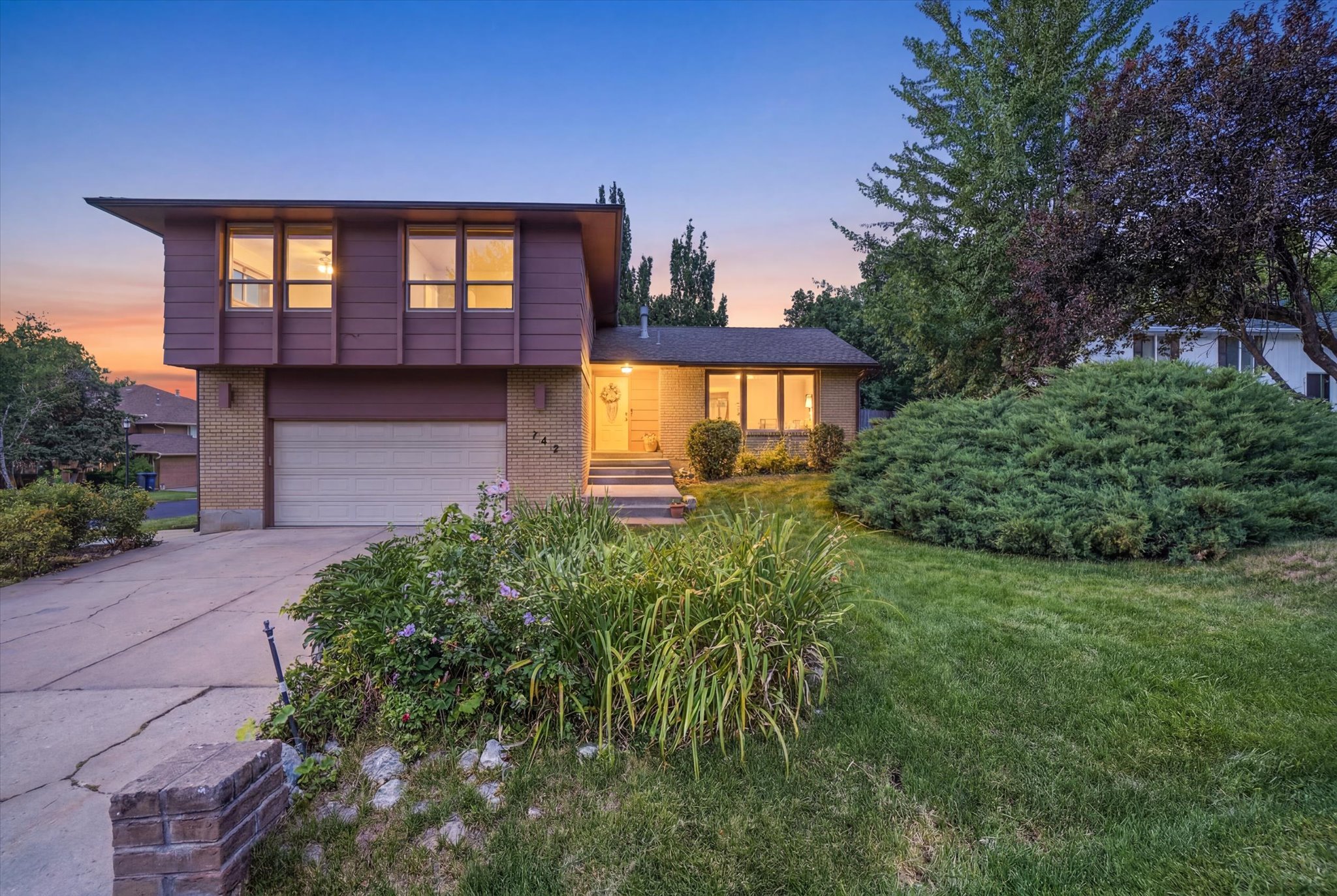 2 Story residence featuring a brick and horizontal siding exterior