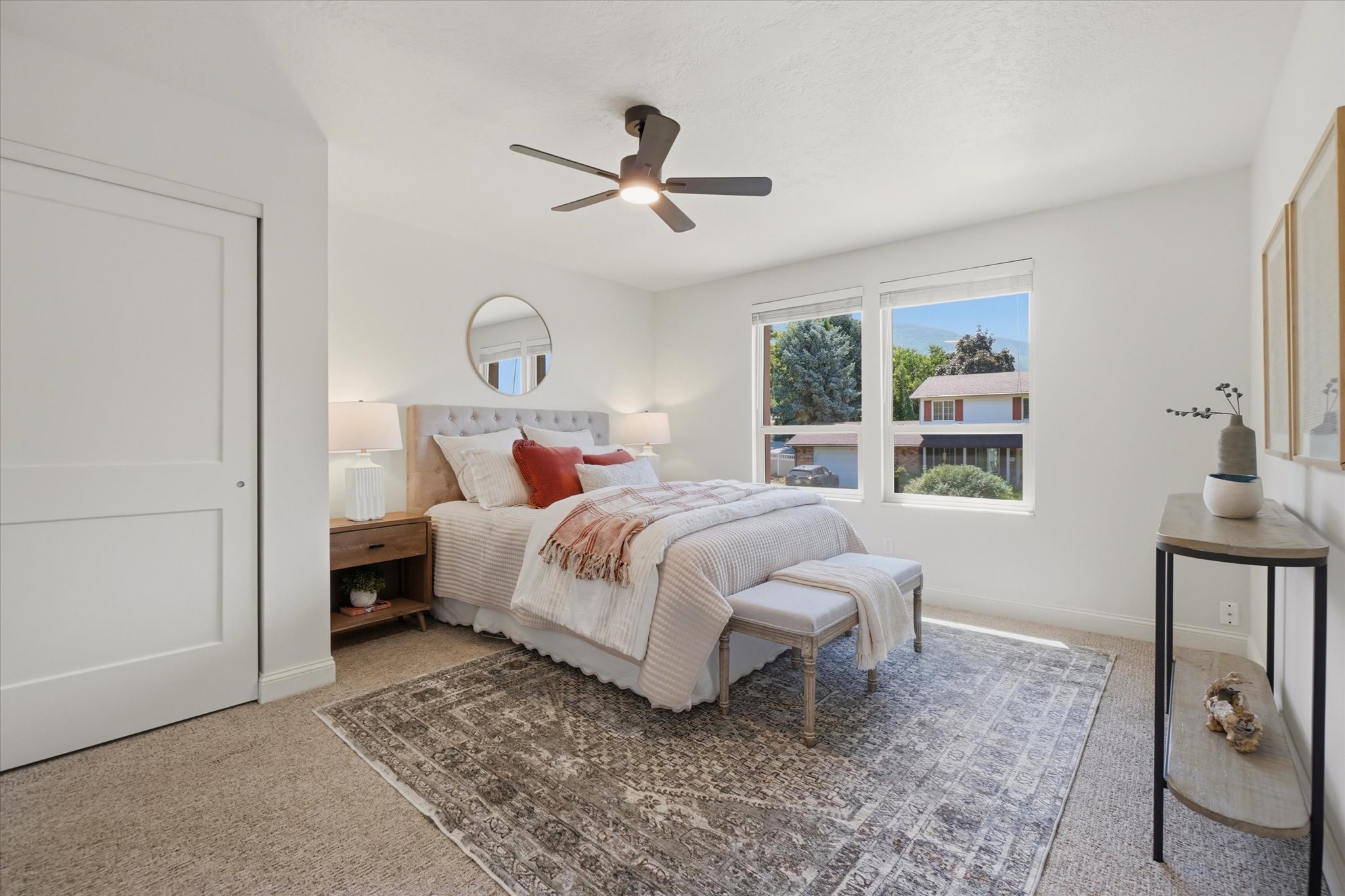 Bright room featuring neutral carpeting and white walls