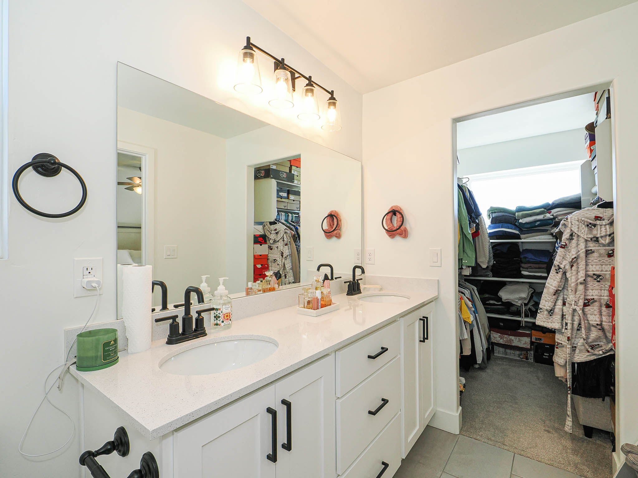 Dual vanity with white cabinetry and quartz-finish countertop