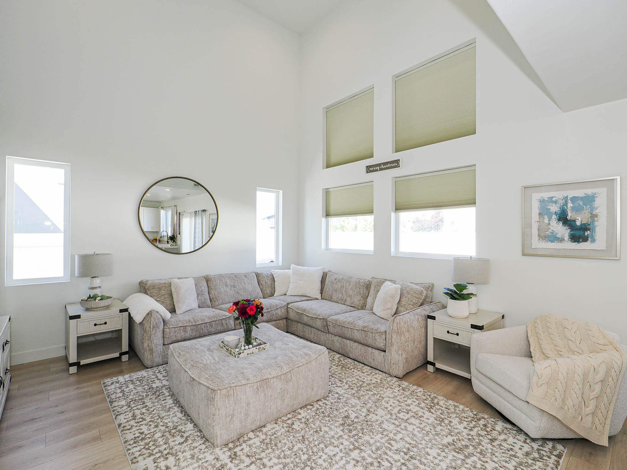 Vaulted ceiling living area featuring wood-finish flooring