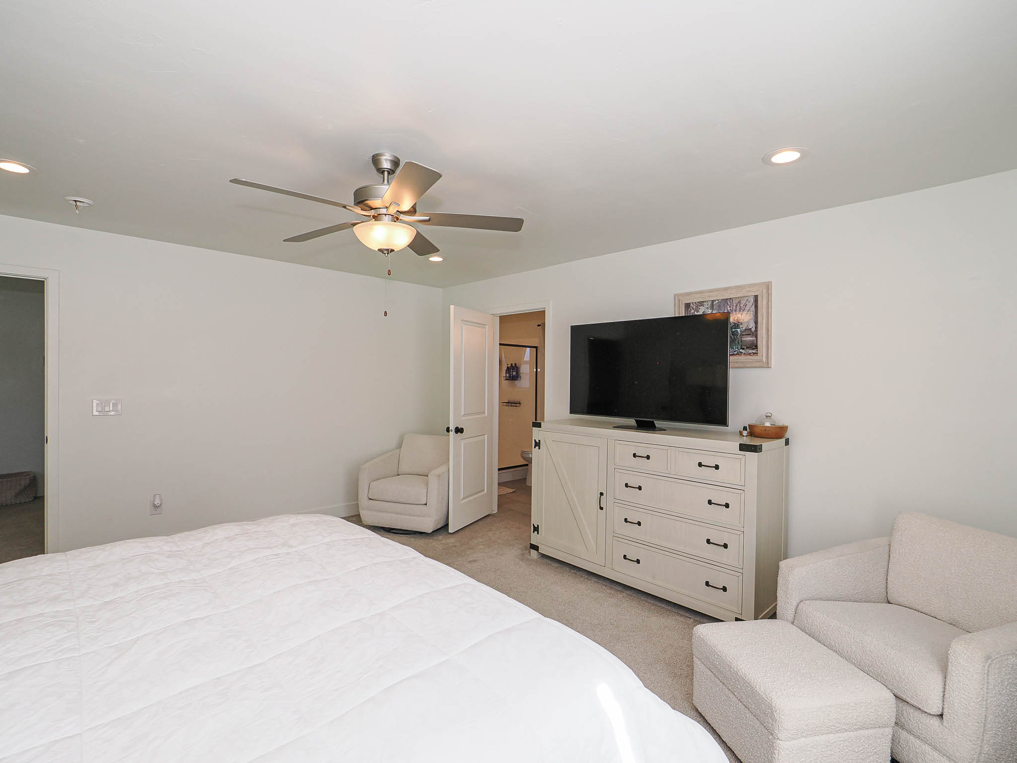 Recessed lighting illumination, ceiling fan, and carpeted flooring
