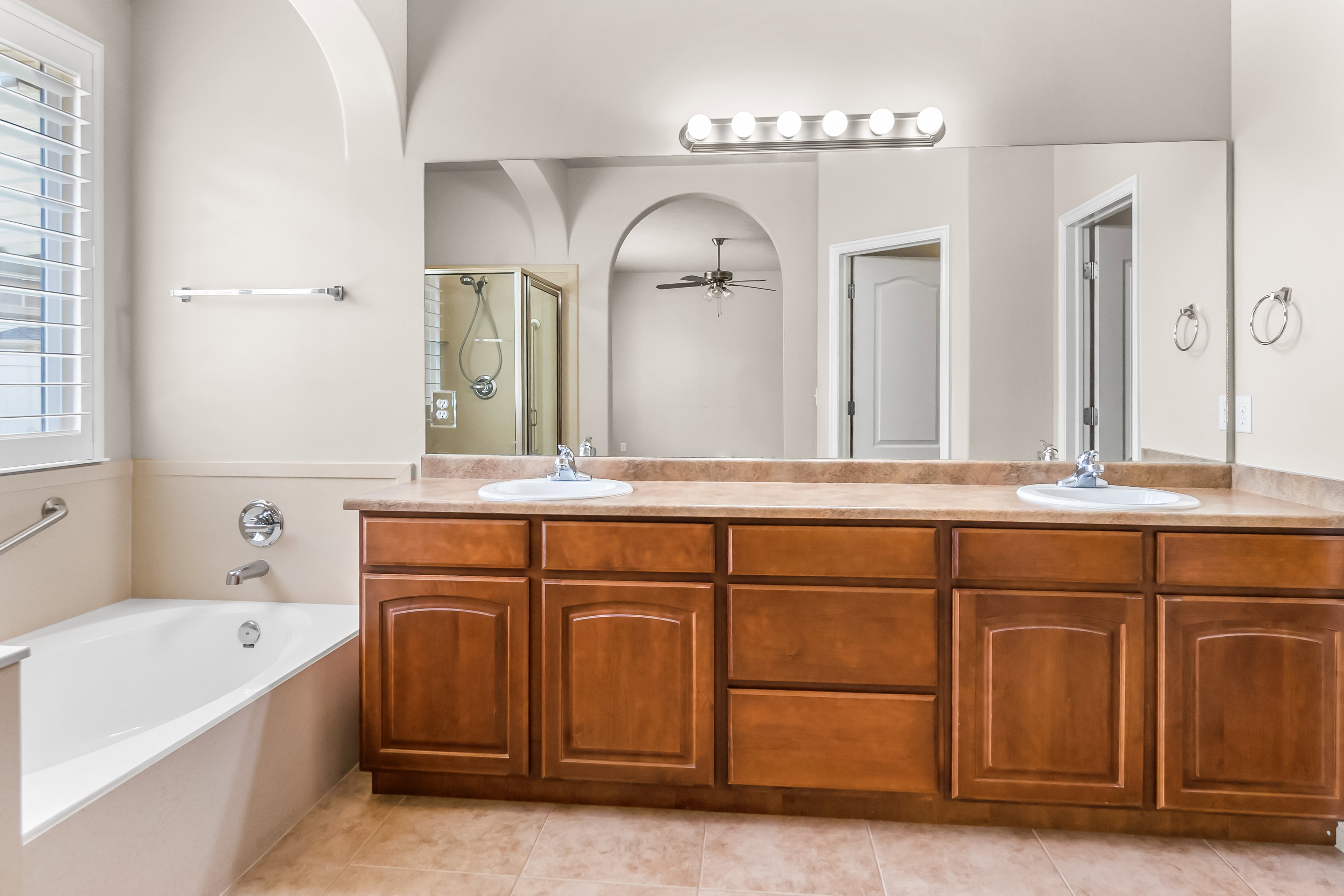 Dual vanity with a stone-finish countertop and wood cabinetry