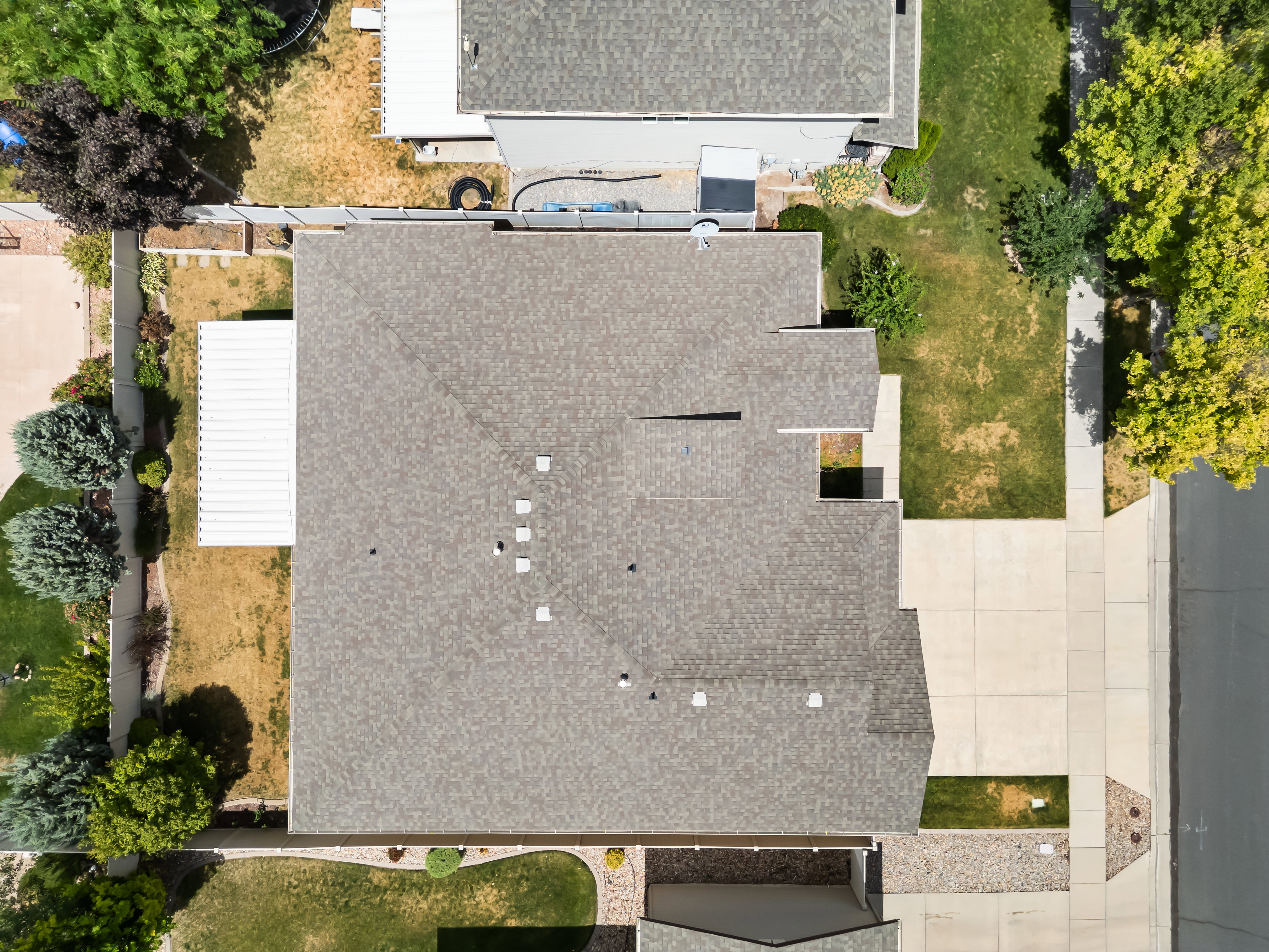 Asphalt shingle roofing over a multi-level structure