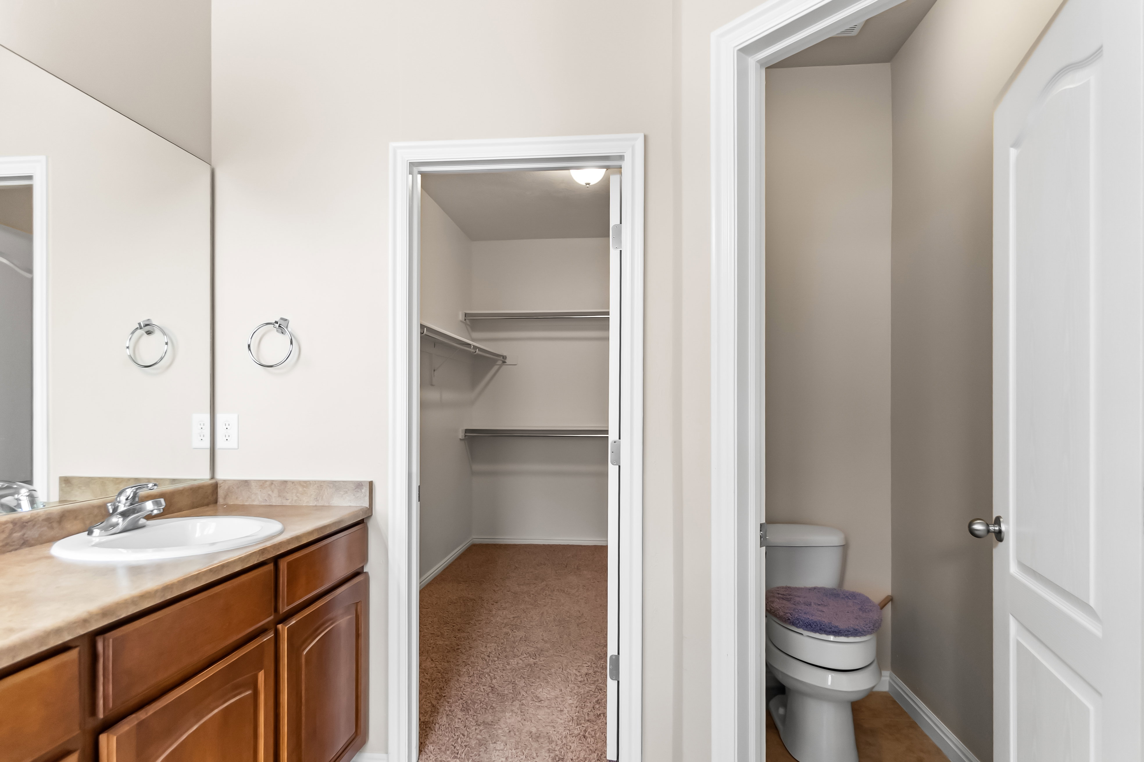 Bathroom vanity featuring a single sink, chrome faucet, and integrated countertop