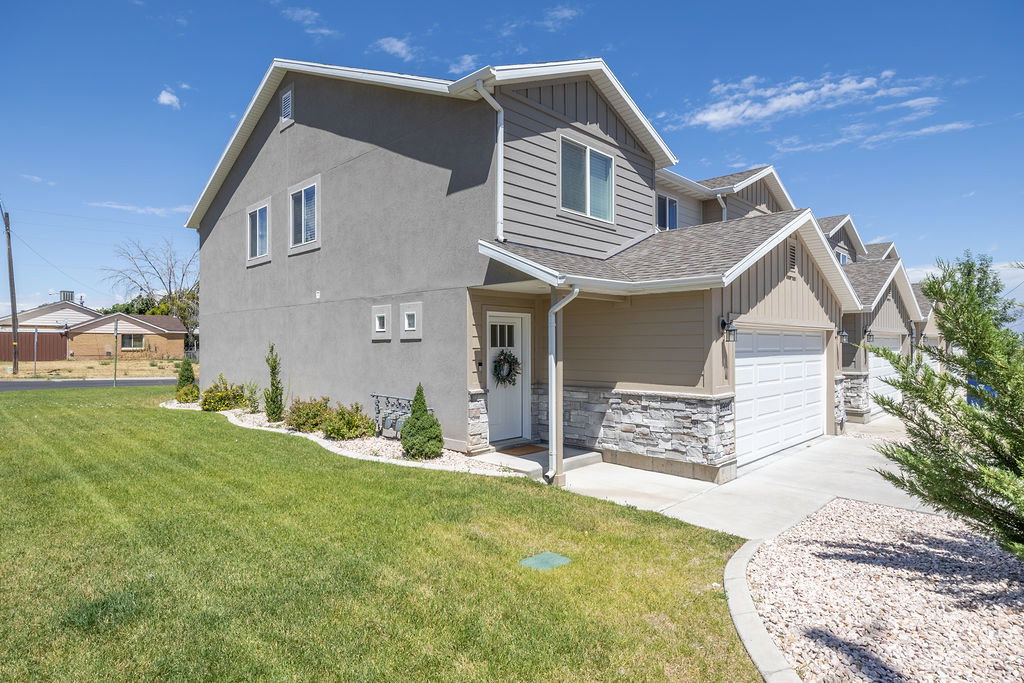 Gray stucco and siding exterior with white trim