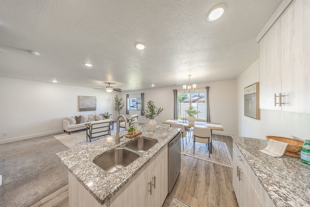 Kitchen island, lots of counter top space.  Open-concept interior.  STAINLESS STEEL appliances will STAY.